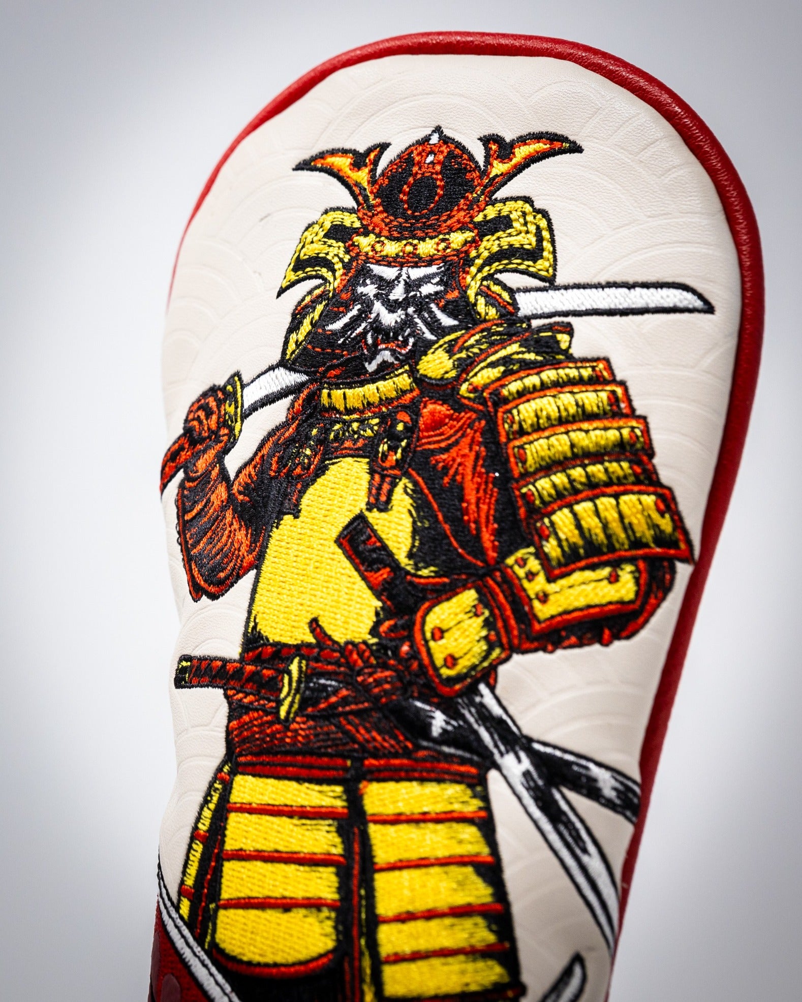 Bold hybrid golf cover featuring a detailed samurai design, showcasing vibrant colors and intricate embroidery.