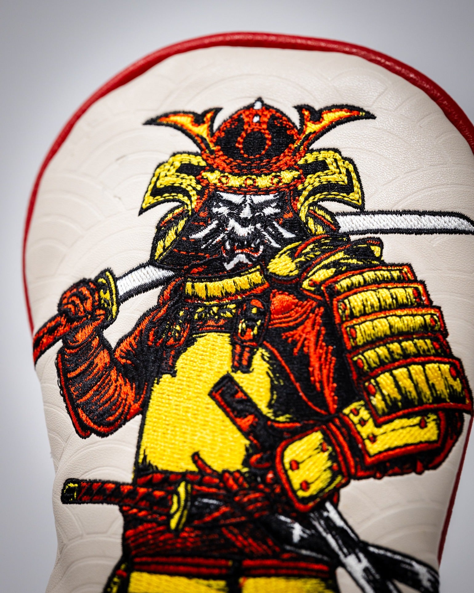 Bold hybrid golf cover featuring a detailed samurai design, showcasing vibrant colors and intricate embroidery.