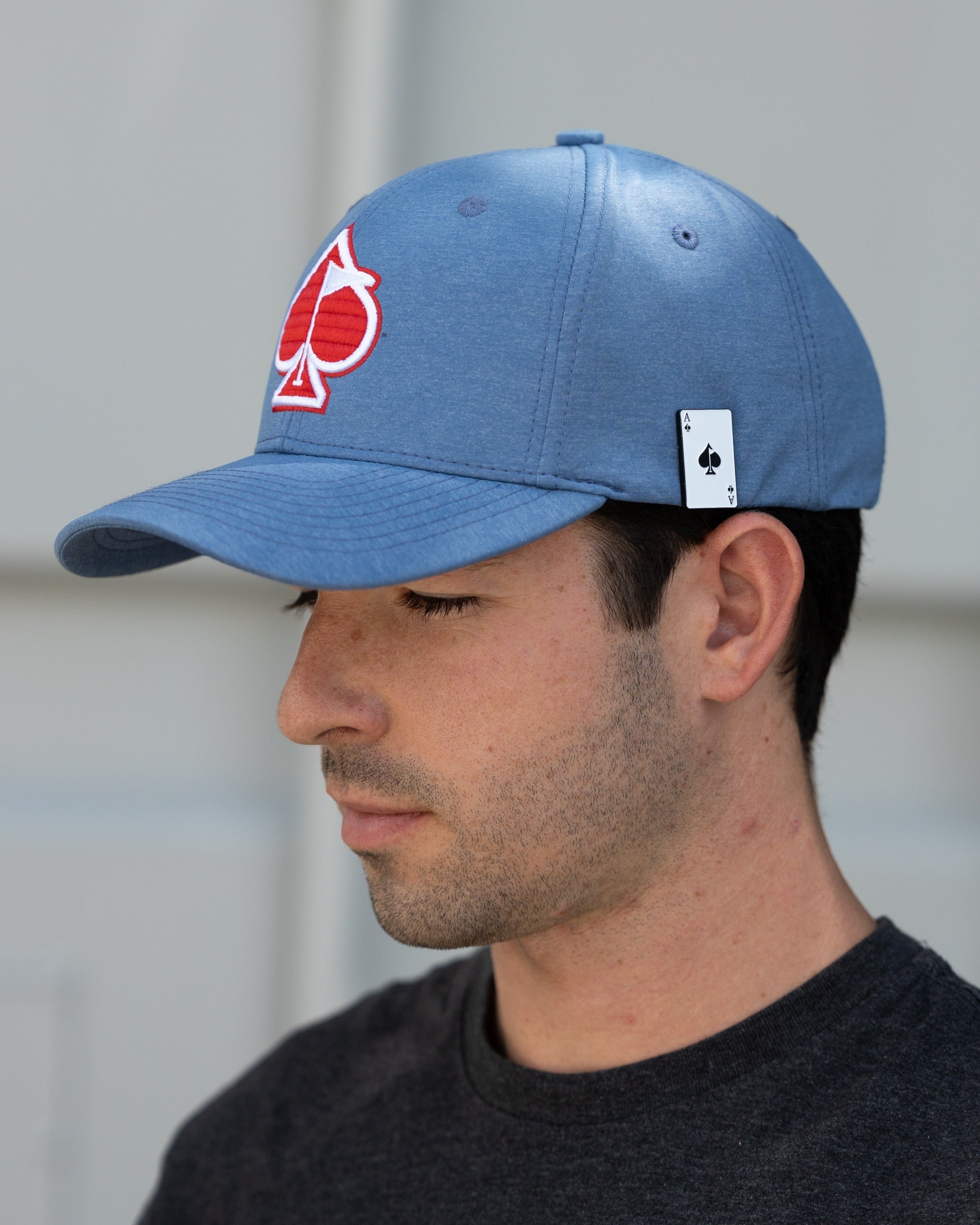 Blue Performance Spade Hat featuring a bold red spade logo, perfect for stylish golfers on the course.