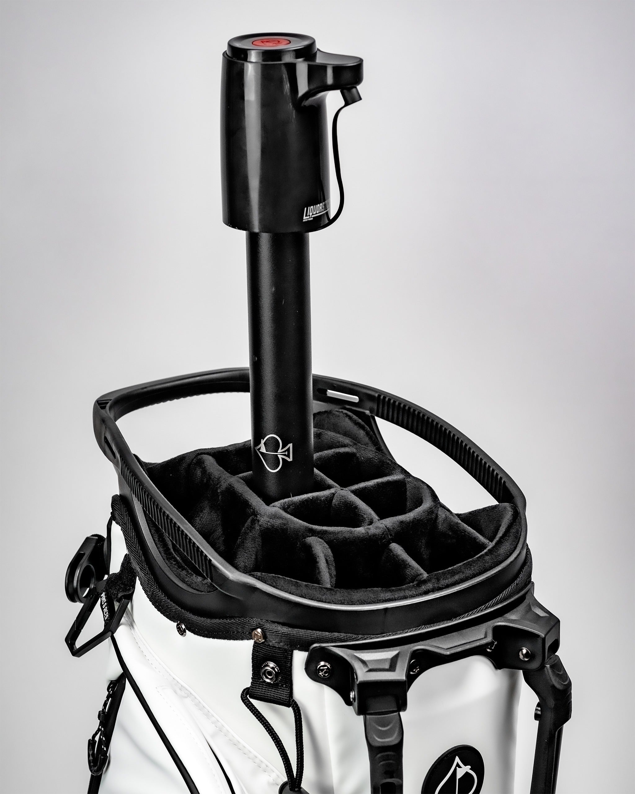 Black LiquorStick 3.0 mounted on a golf bag, featuring a sleek design and storage compartments for accessories.