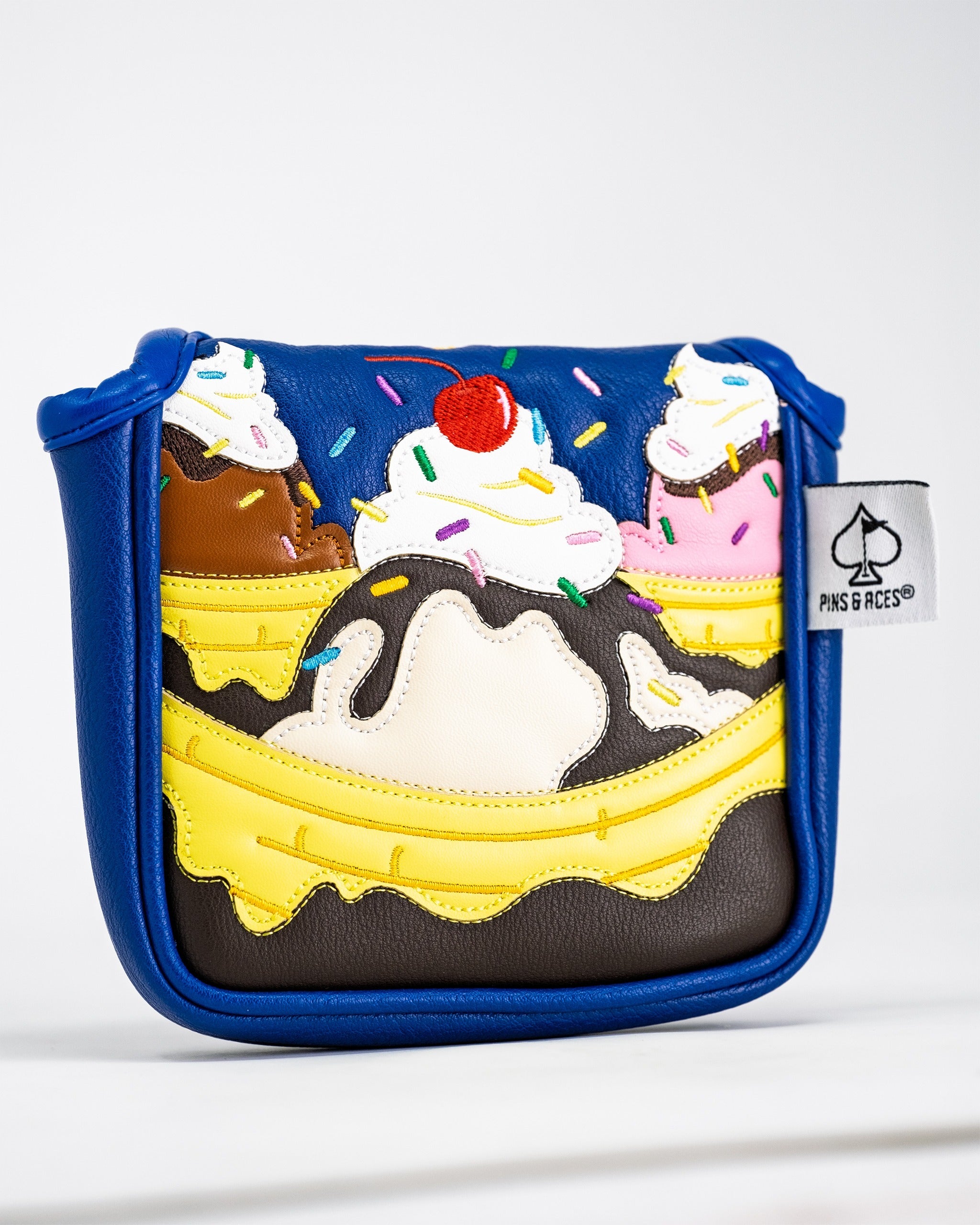 Colorful mallet putter cover designed like a banana split, featuring ice cream scoops and a cherry on top.