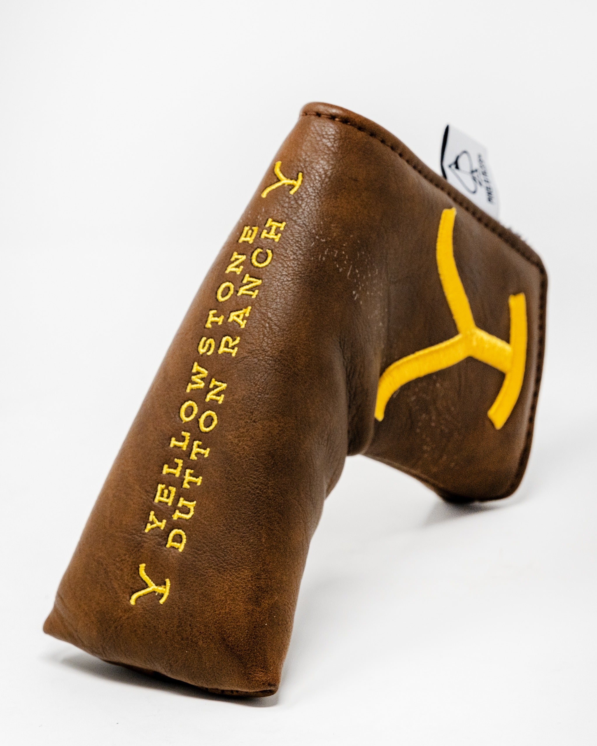 Brown leather blade putter cover featuring yellow Yellowstone Dutton Ranch logo, designed for stylish golf protection.