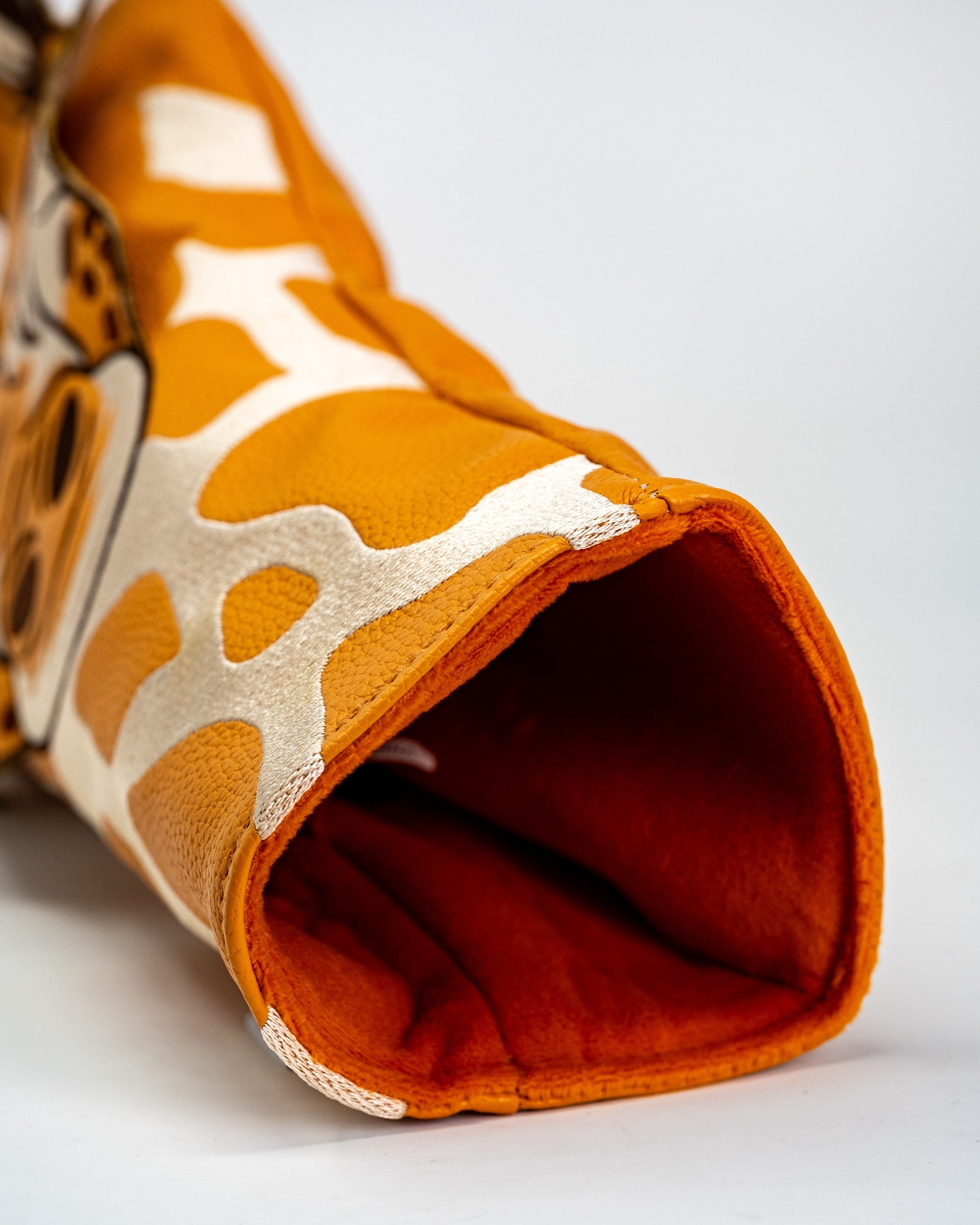 Giraffe driver cover featuring a vibrant orange and cream design, perfect for adding personality to your golf bag.