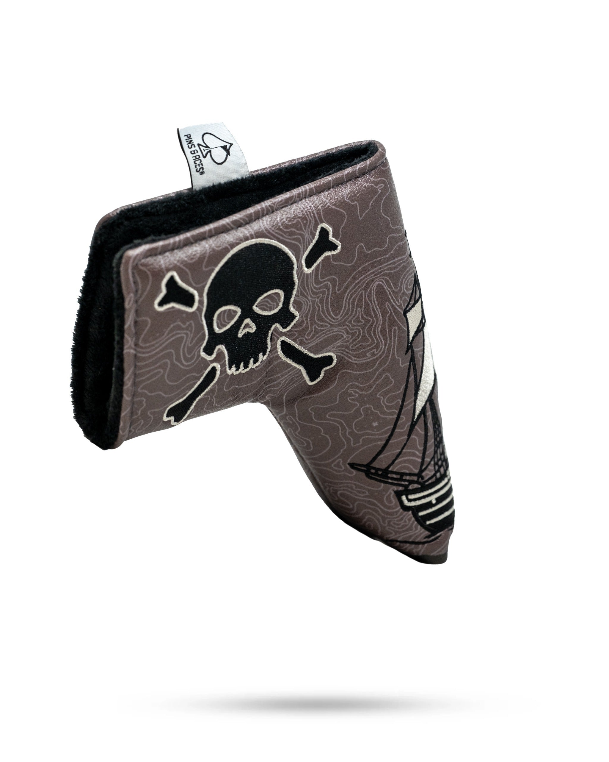 Bold pirate-themed blade putter cover featuring a skull and crossbones design with a ship, perfect for standout golfers.