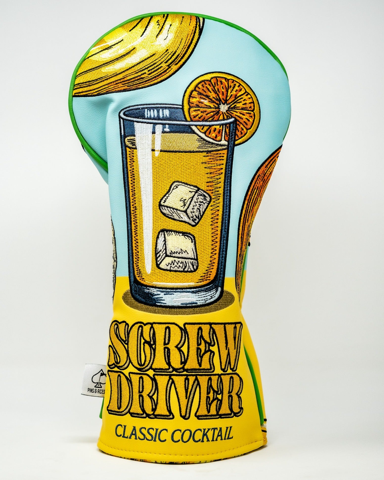Colorful golf driver cover featuring a classic cocktail design with a glass, ice, and orange slice, labeled "Screw Driver.