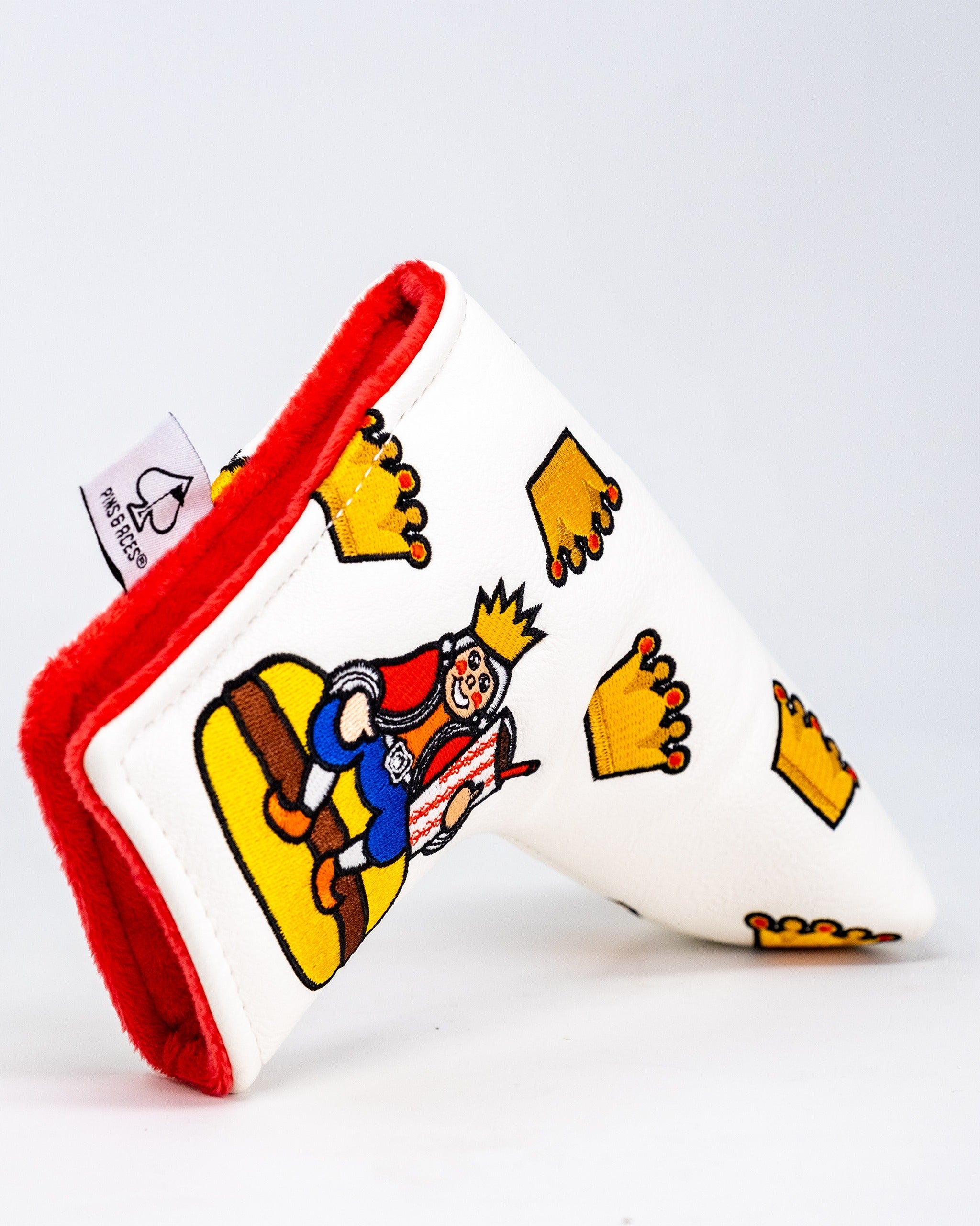 White blade putter cover featuring a cartoon king with crowns, designed for golfers seeking a fun, bold accessory.