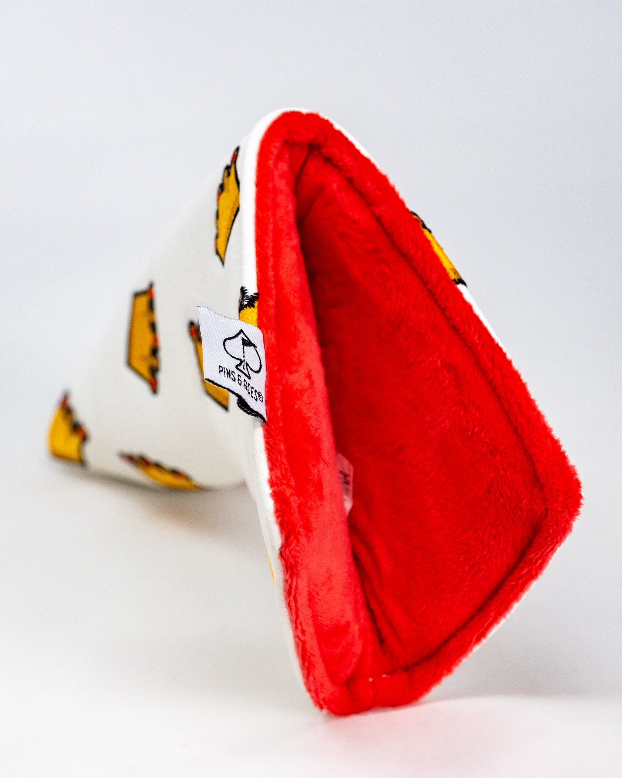 White blade putter cover featuring a fun crown design with a soft red interior, perfect for stylish golfers.