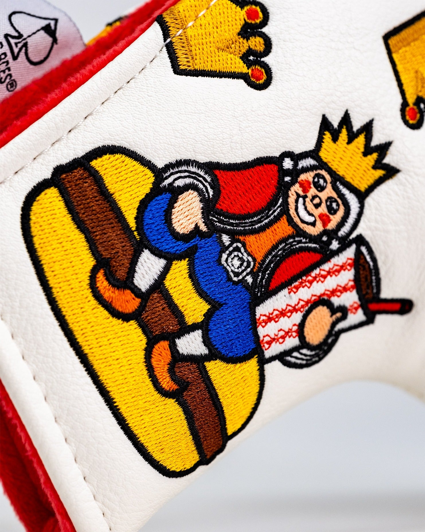 Colorful Bogey King blade putter headcover featuring a playful king character enjoying a burger and drink.