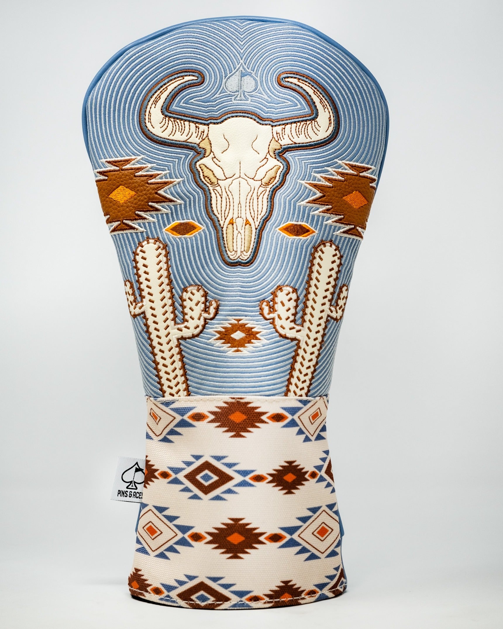 Western aesthetic driver cover featuring a bull skull design, cacti, and geometric patterns in earthy tones.