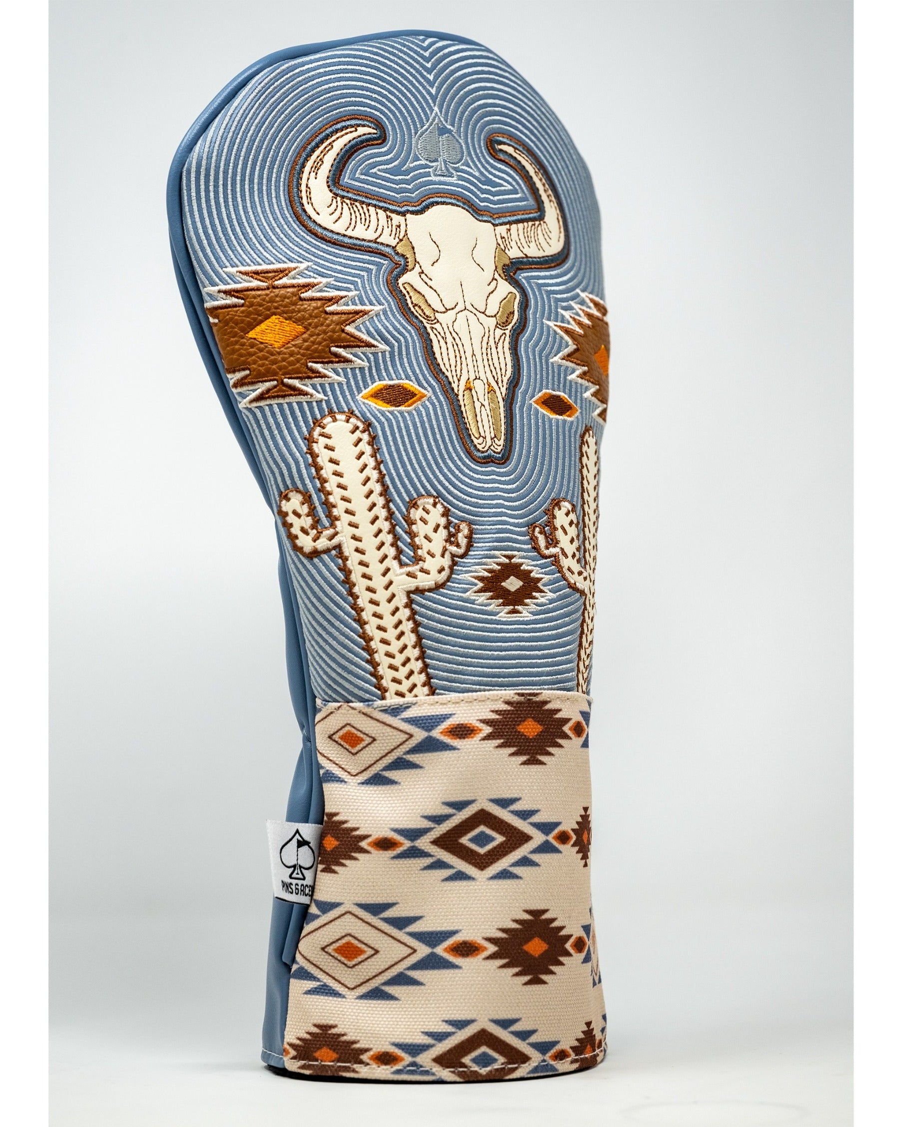 Western aesthetic driver cover featuring a skull design, cacti, and geometric patterns in earthy tones. Ideal for stylish golfers.