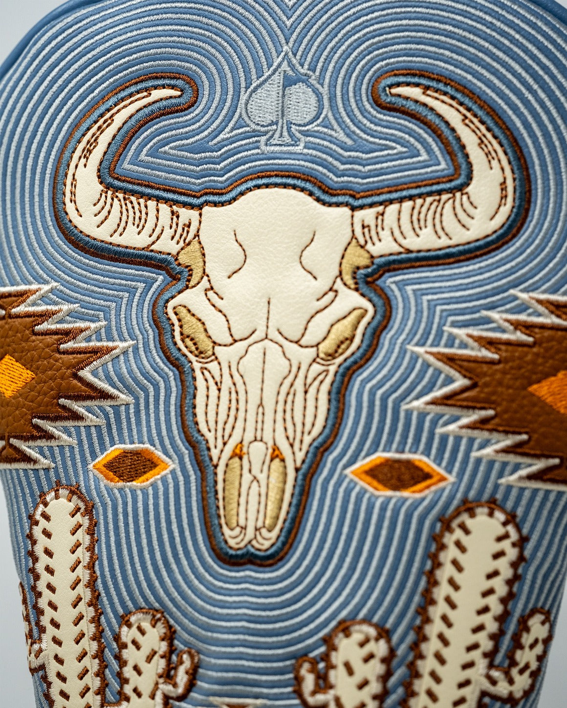 Western aesthetic driver cover featuring a detailed skull design with cacti and geometric patterns in earthy tones.