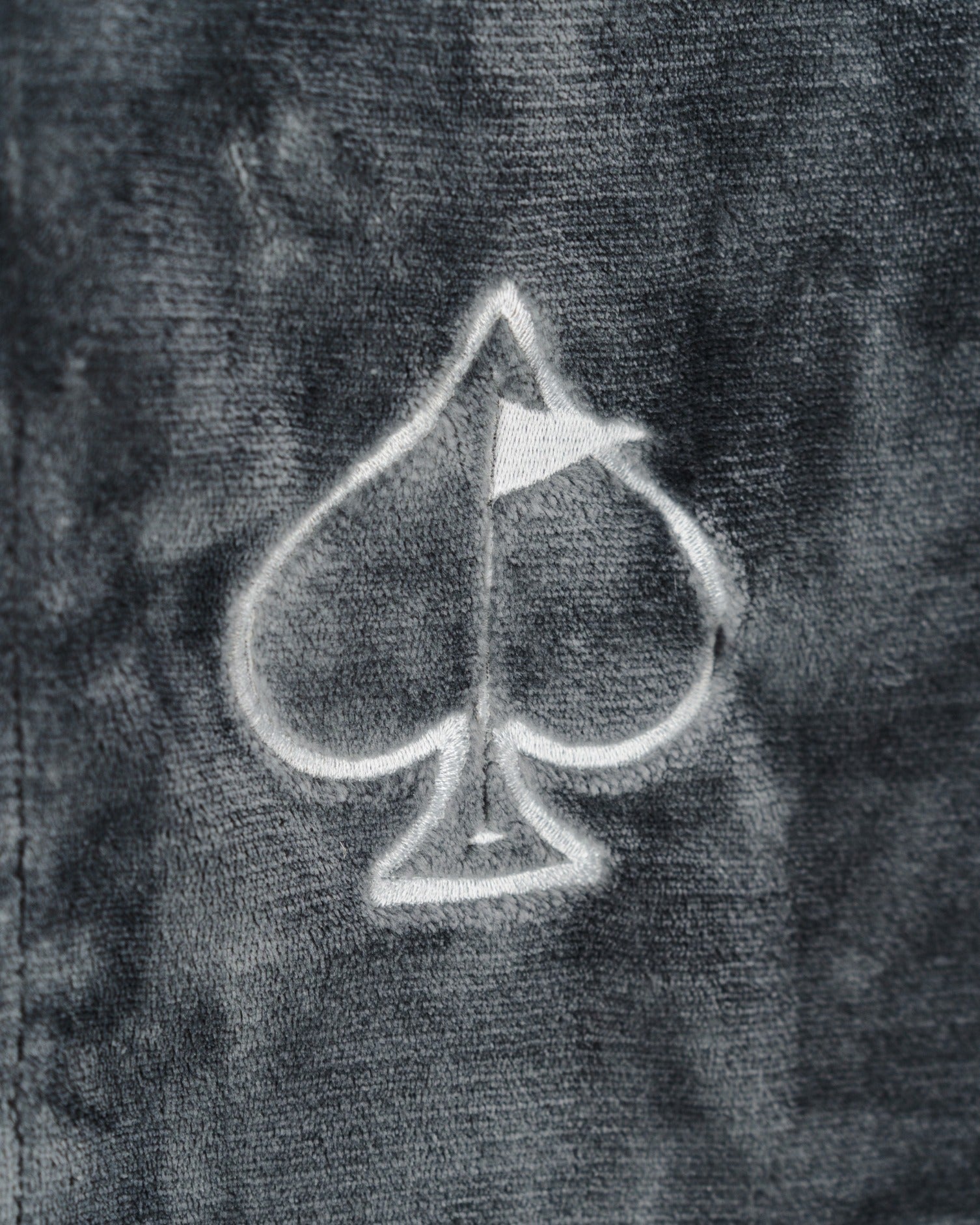 Dark gray Bogey Blanket featuring a subtle spade logo, perfect for cozying up on and off the golf course.