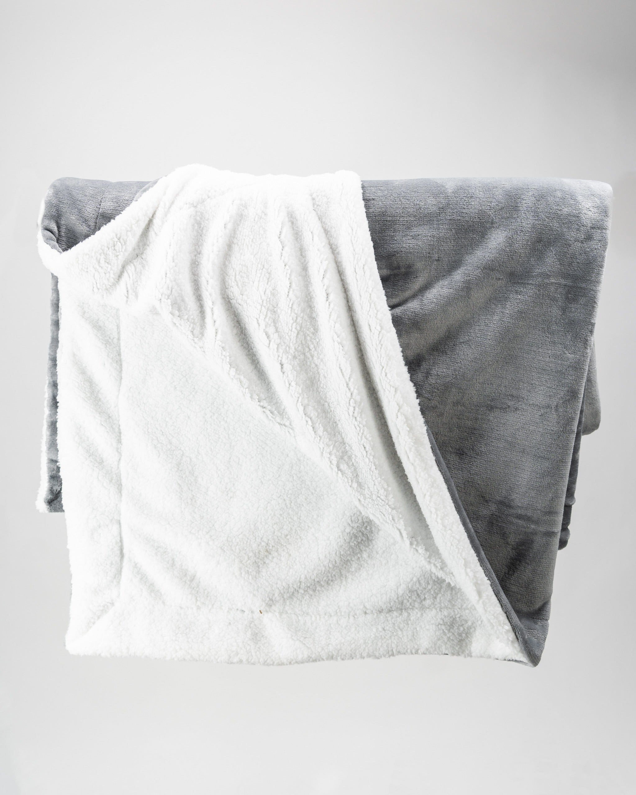 Light gray Bogey Blanket featuring a soft, plush texture with a cozy white underside, perfect for golfers' comfort.