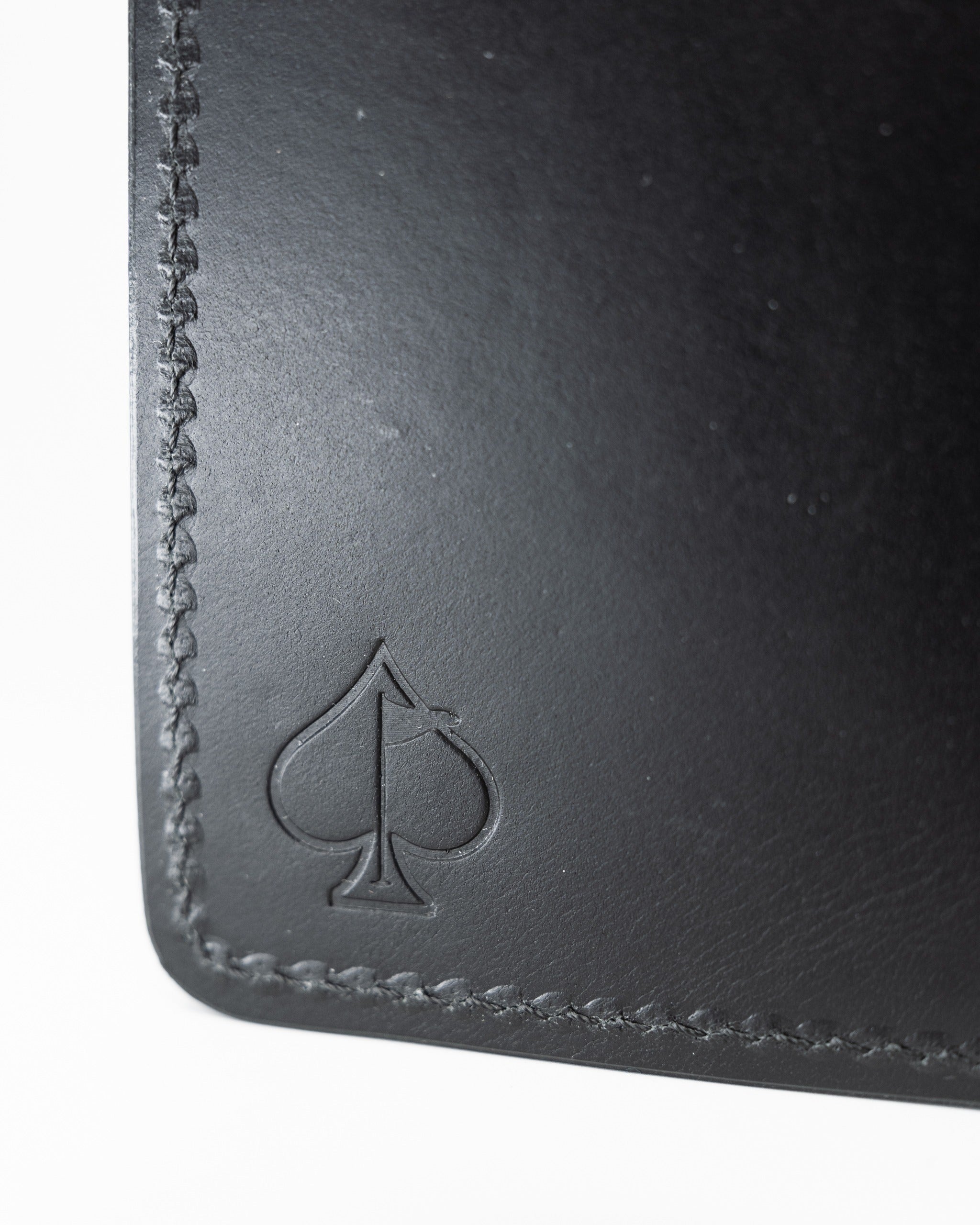 Smooth Italian black wallet featuring a subtle spade logo and refined stitching, perfect for stylish golfers.