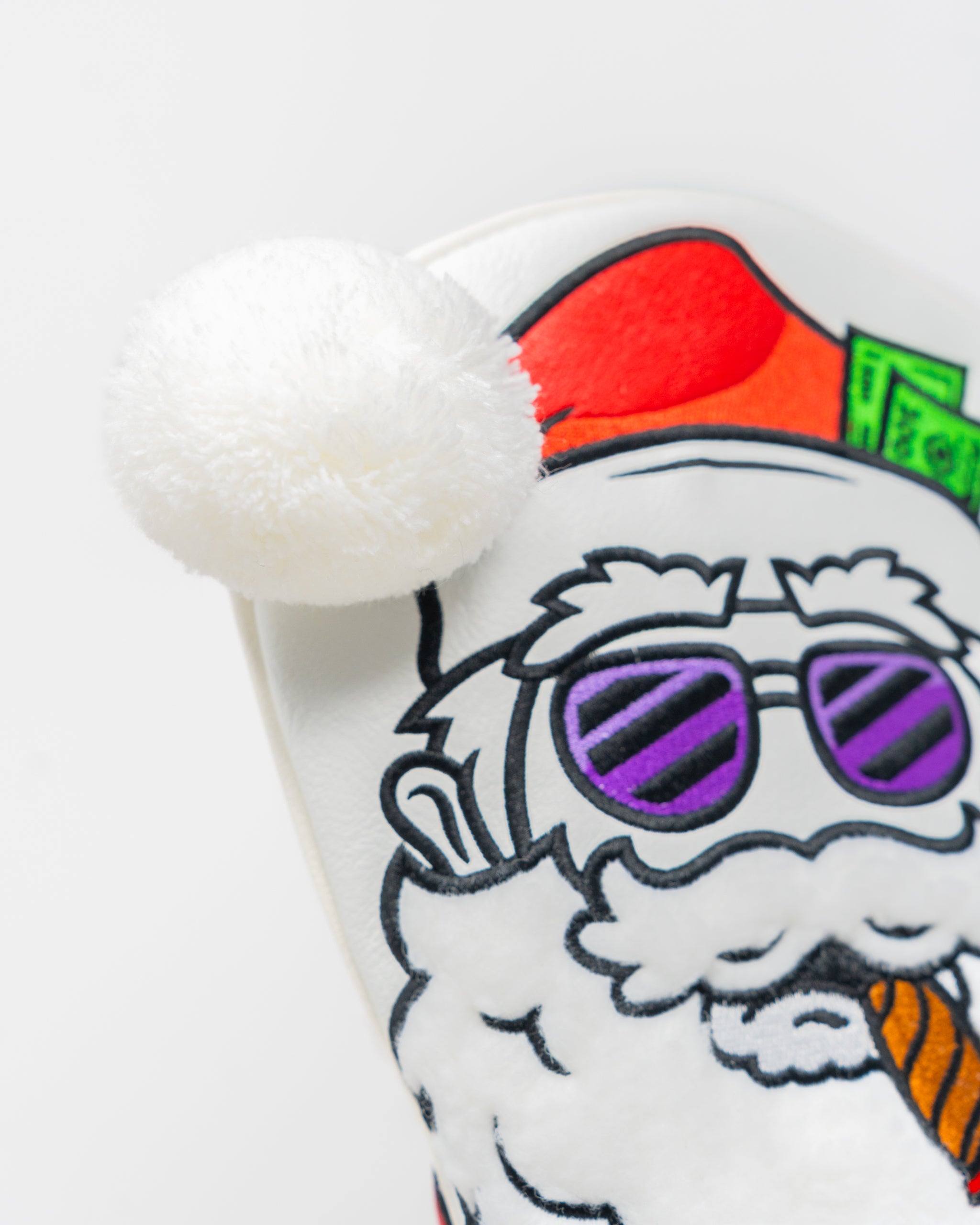 Bold Santa-themed driver cover featuring a playful design with sunglasses and a pom-pom on top, perfect for festive golfers.