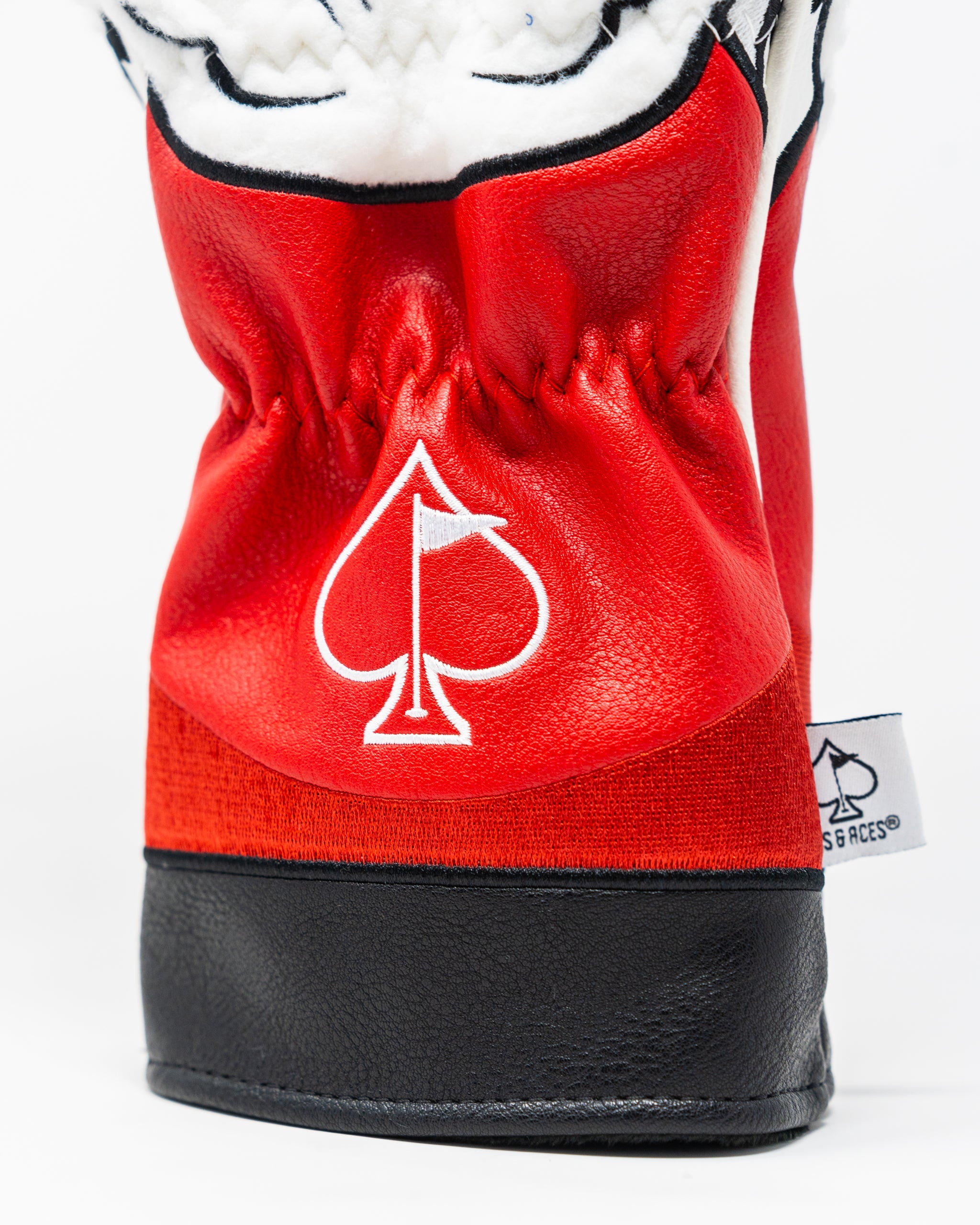 Bold red driver cover featuring a playful Santa design and an embroidered spade logo, perfect for festive golfers.