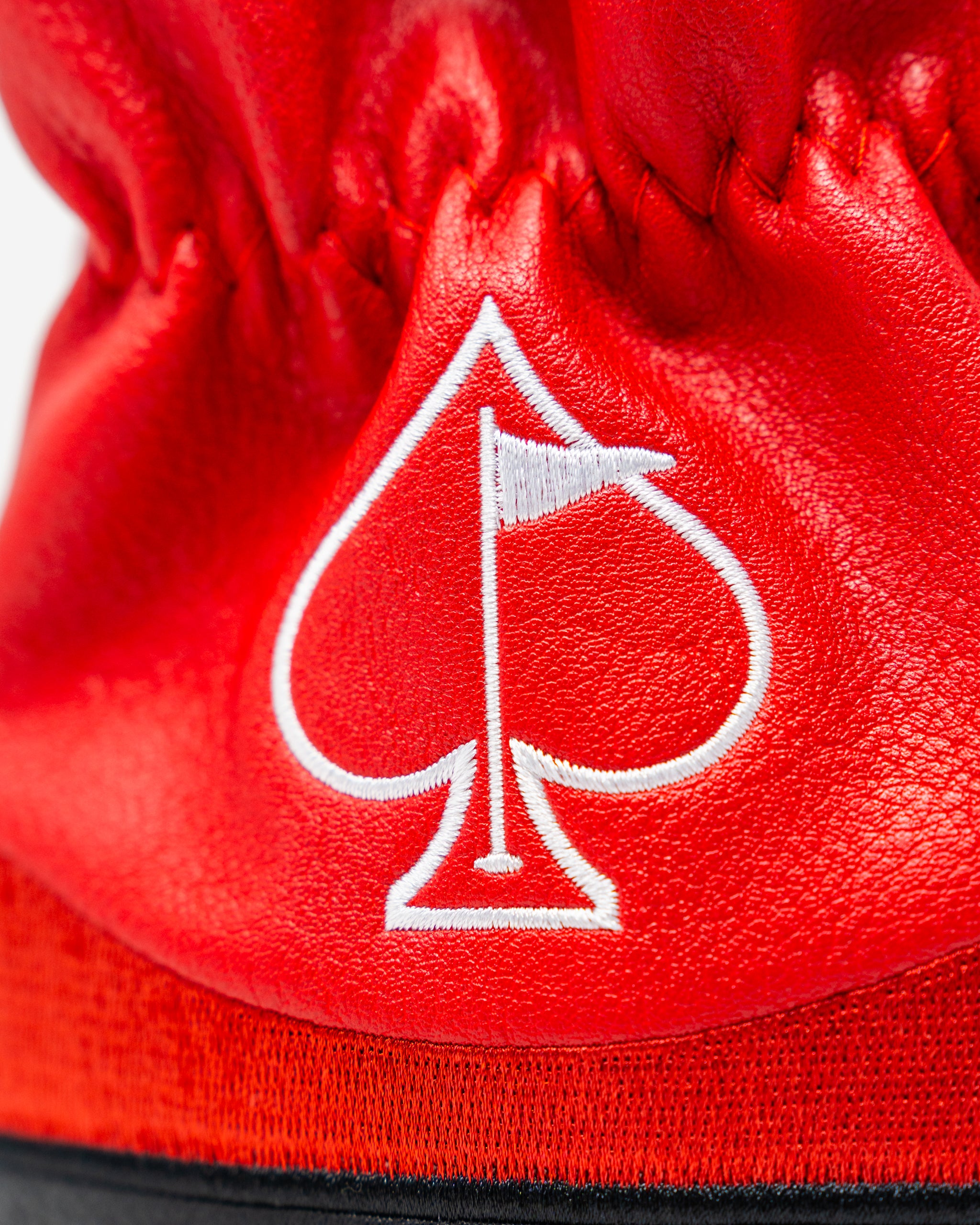 Bold red driver cover featuring a white spade logo with a flag, designed for golfers who want to make a statement on the course.