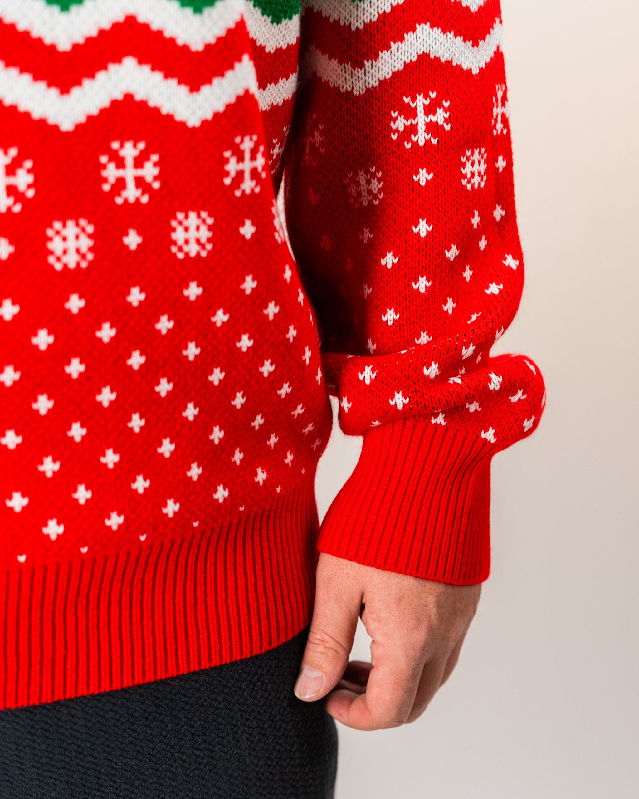 Red holiday sweater featuring festive patterns and snowflakes, perfect for golfers wanting to showcase their style on the course.