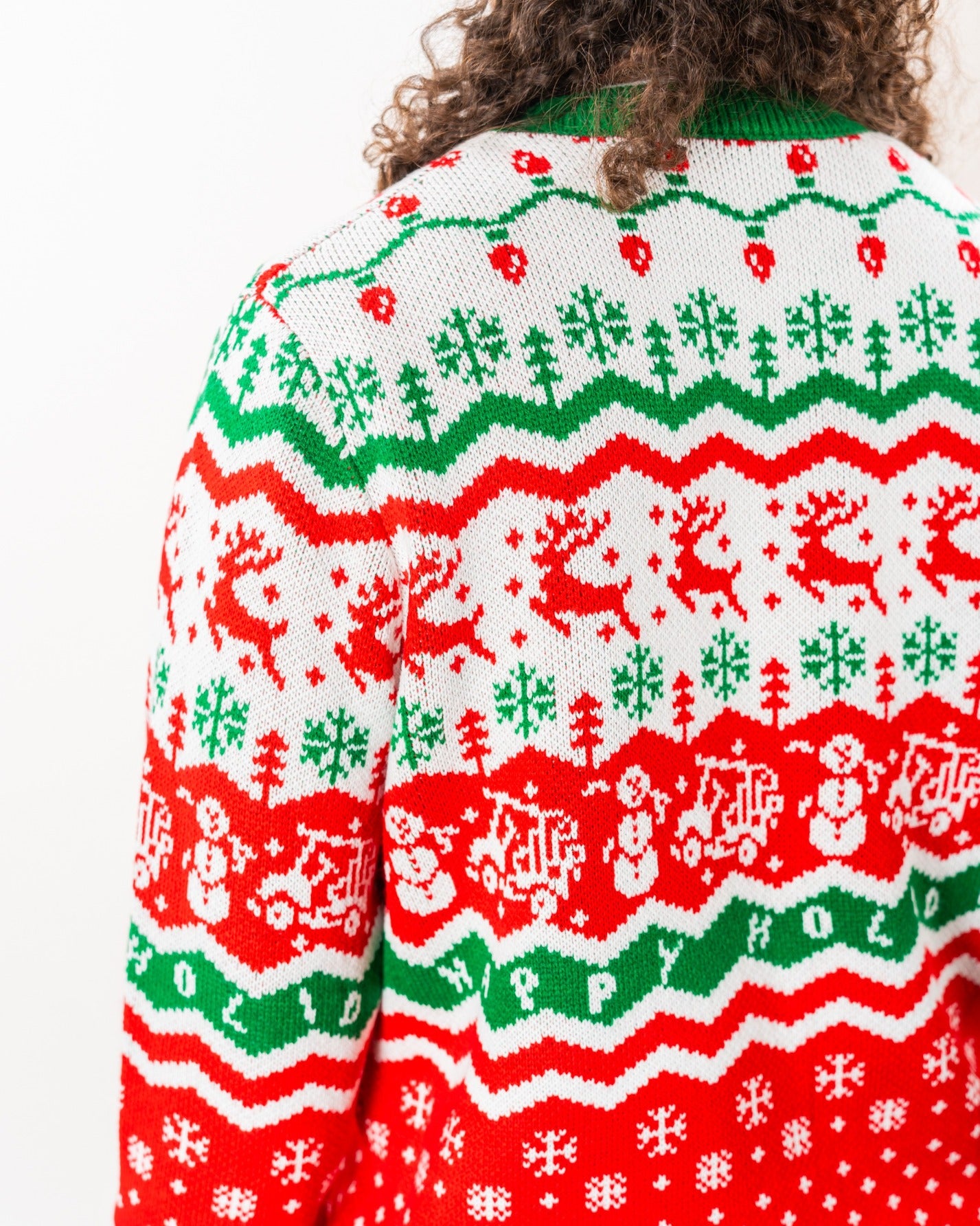 Colorful holiday sweater featuring reindeer, snowmen, and festive patterns, perfect for golf enthusiasts.