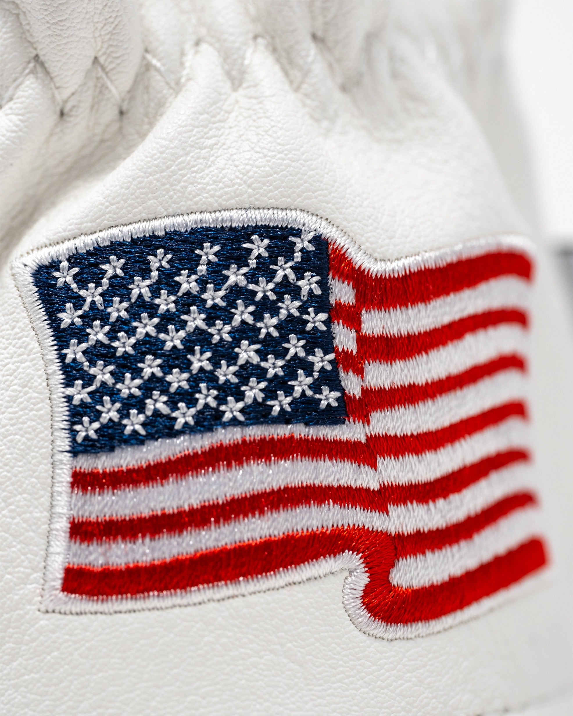 White hybrid golf cover featuring an embroidered American flag design, perfect for golfers seeking a patriotic touch.