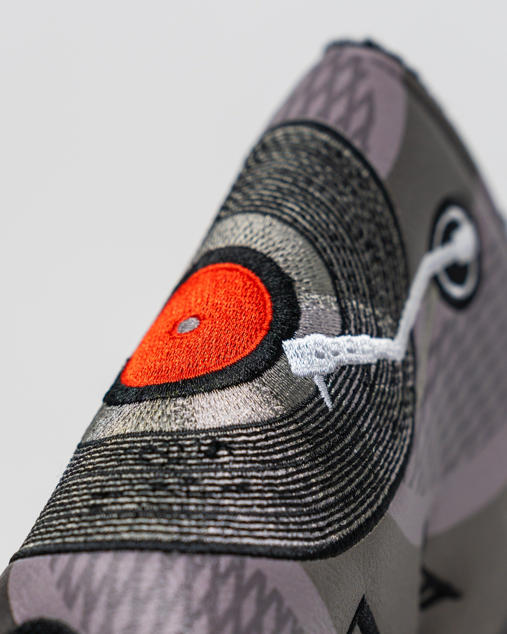 Music City blade putter cover featuring a vibrant vinyl record design with intricate embroidery details.