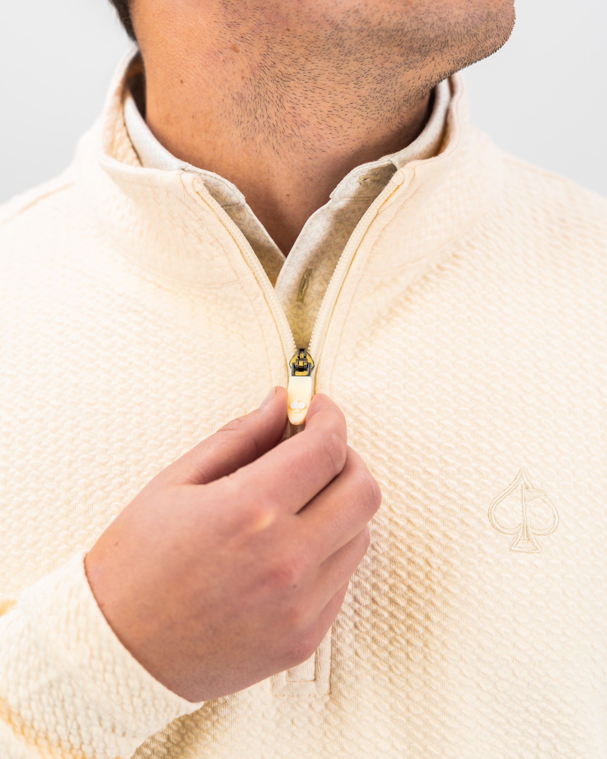 Cream Player Preferred Waffle Knit Pullover featuring a half-zip design and subtle logo, ideal for stylish golf outings.