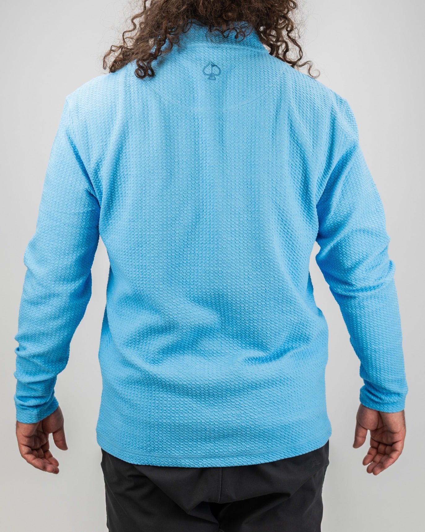 Men's blue steel waffle knit pullover with long sleeves, featuring a stylish back logo, perfect for golf enthusiasts.