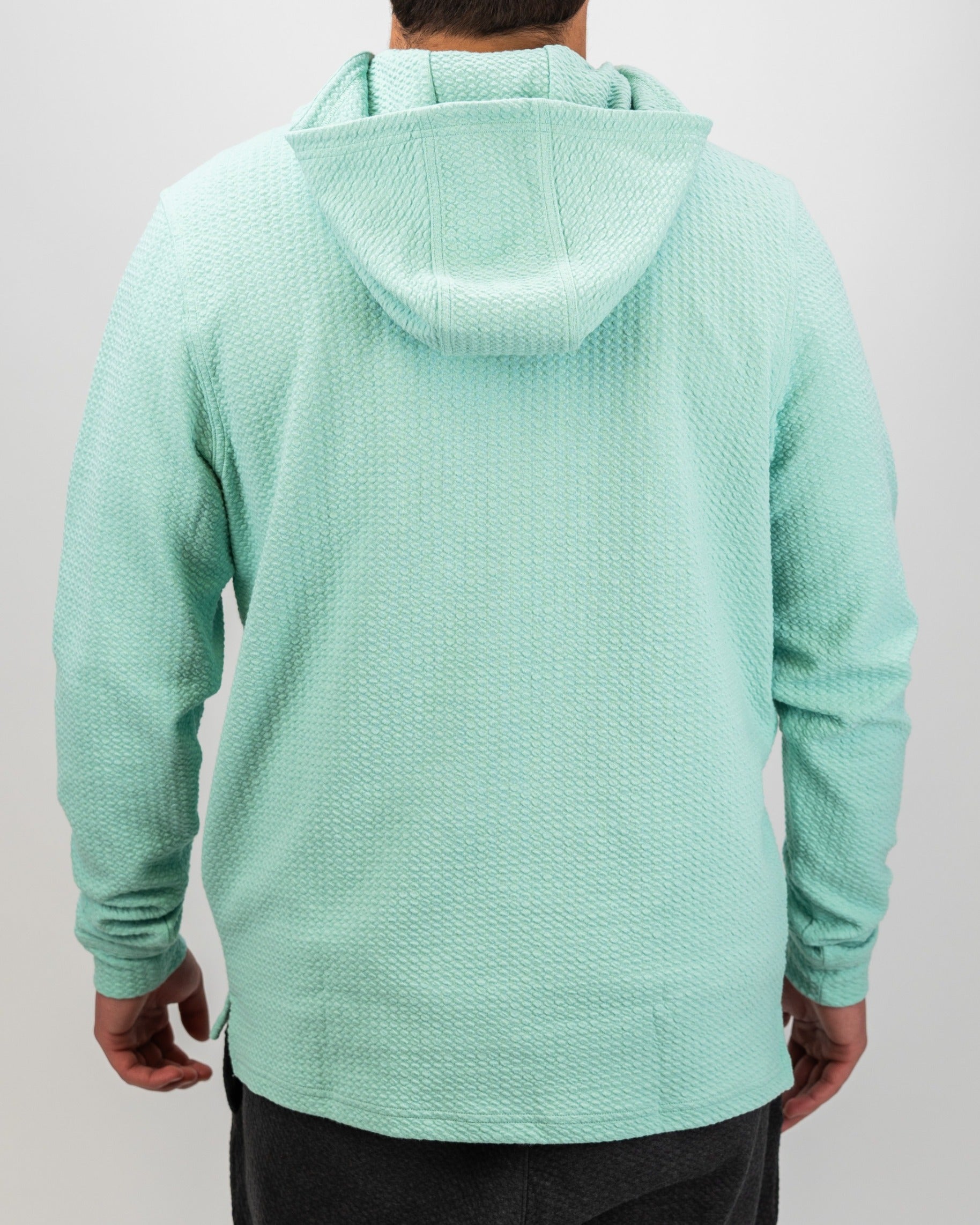Bright mint waffle knit hoodie for men, featuring a relaxed fit and a cozy hood, perfect for stylish comfort on the golf course.