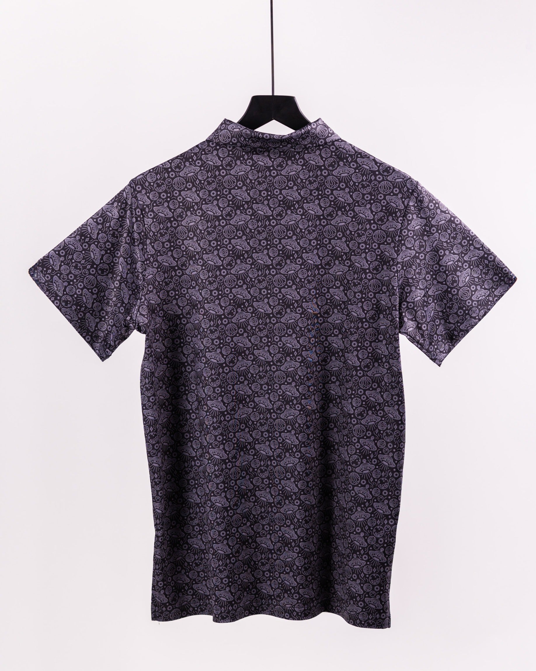 Black short-sleeve shirt featuring a unique black and gray patterned design, hanging against a plain background.