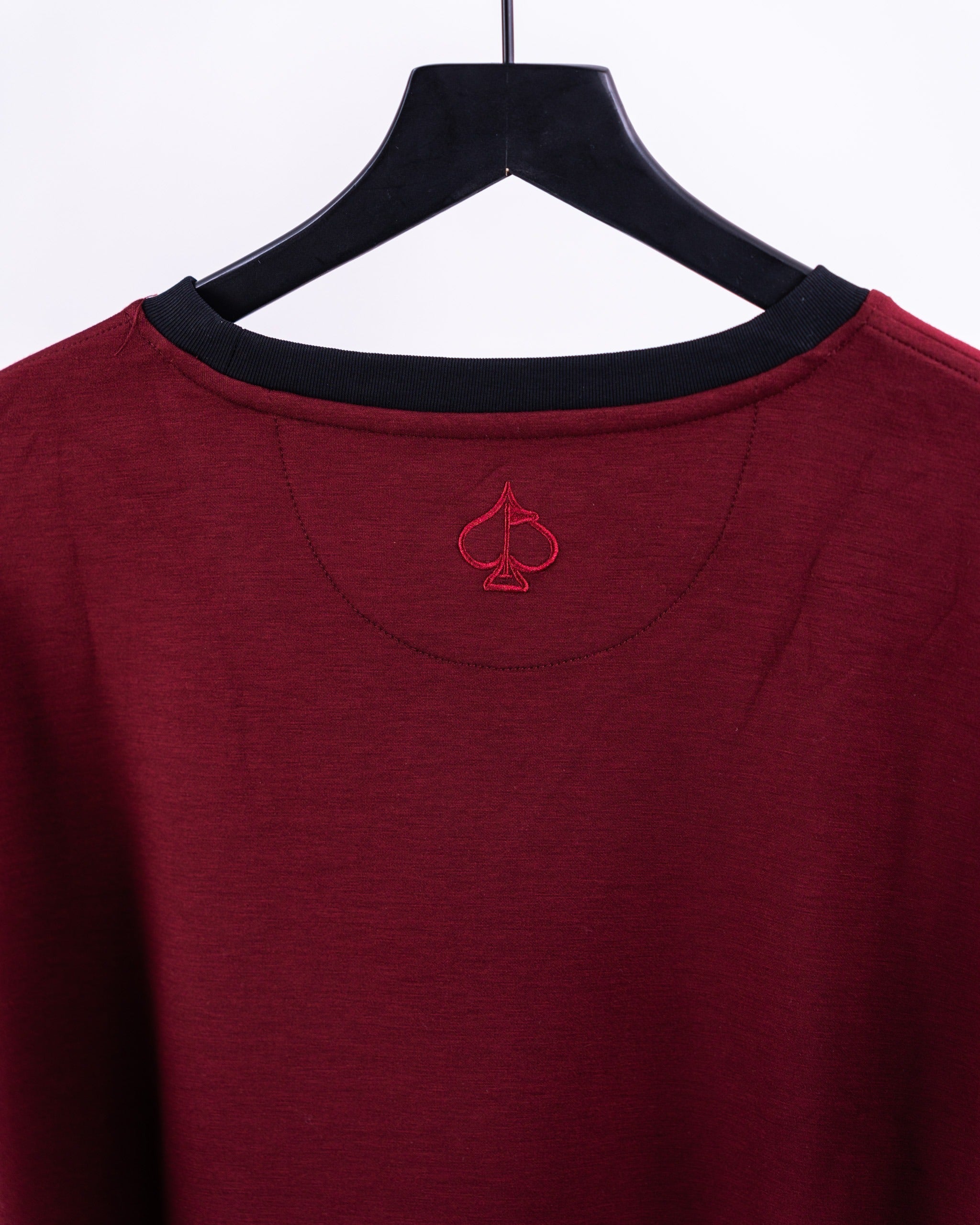 Merlot crewneck featuring a subtle embroidered spade logo on the back, perfect for stylish golfers.