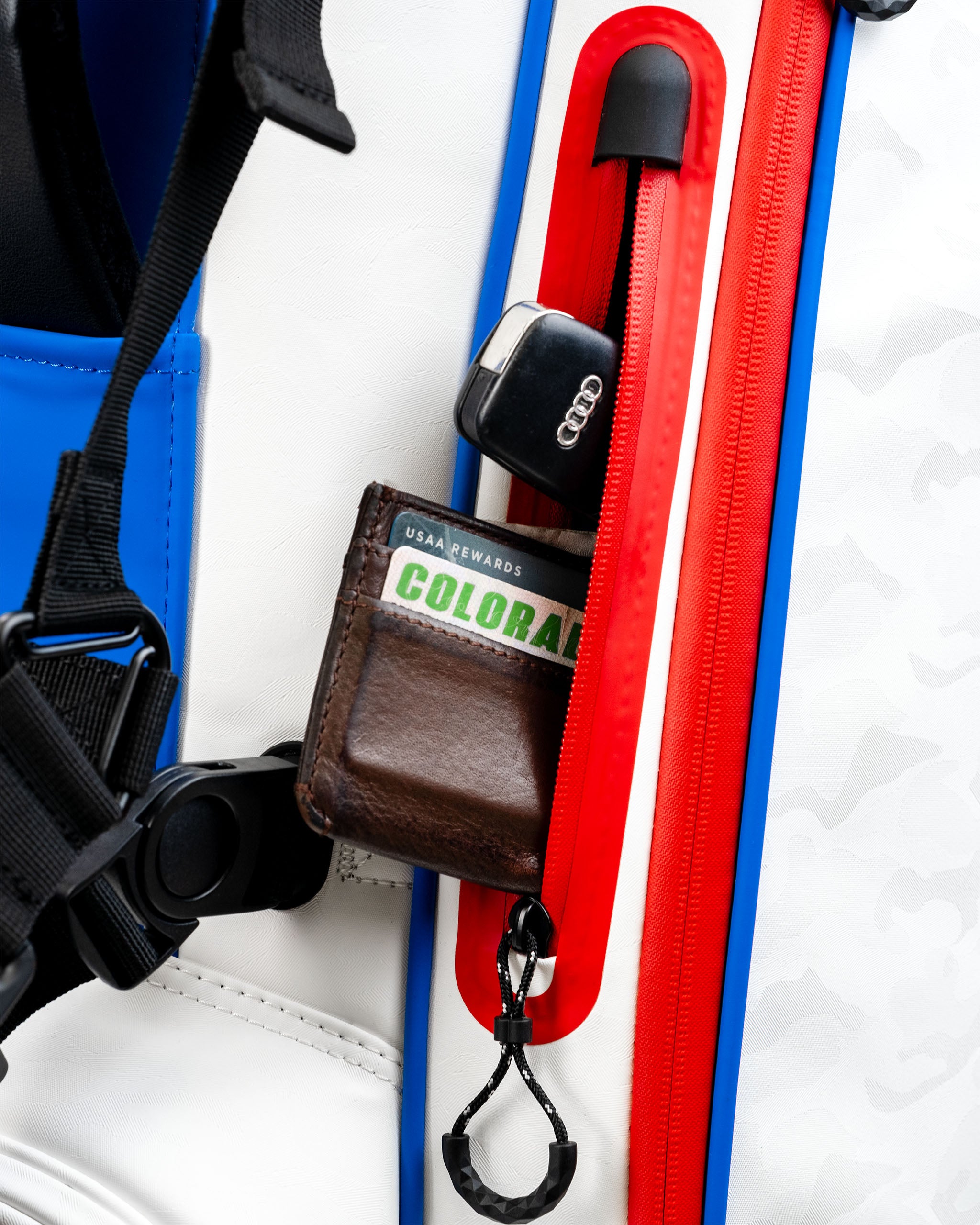 Close-up of the Player Preferred Golf Bag featuring a zippered pocket with a wallet and car key, showcasing its practical design.