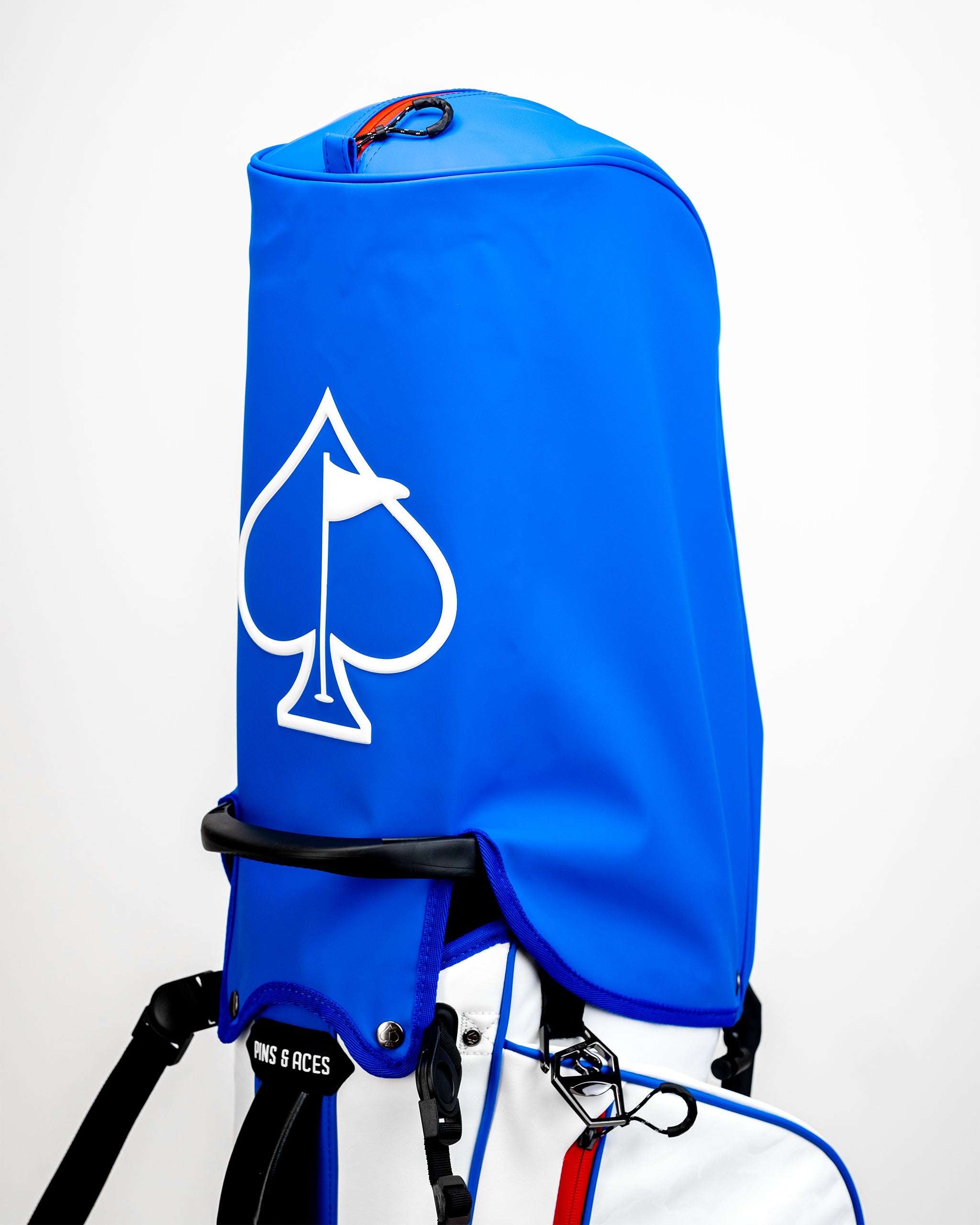 Bold blue golf bag featuring a large white spade logo, designed for golfers seeking style and functionality on the course.