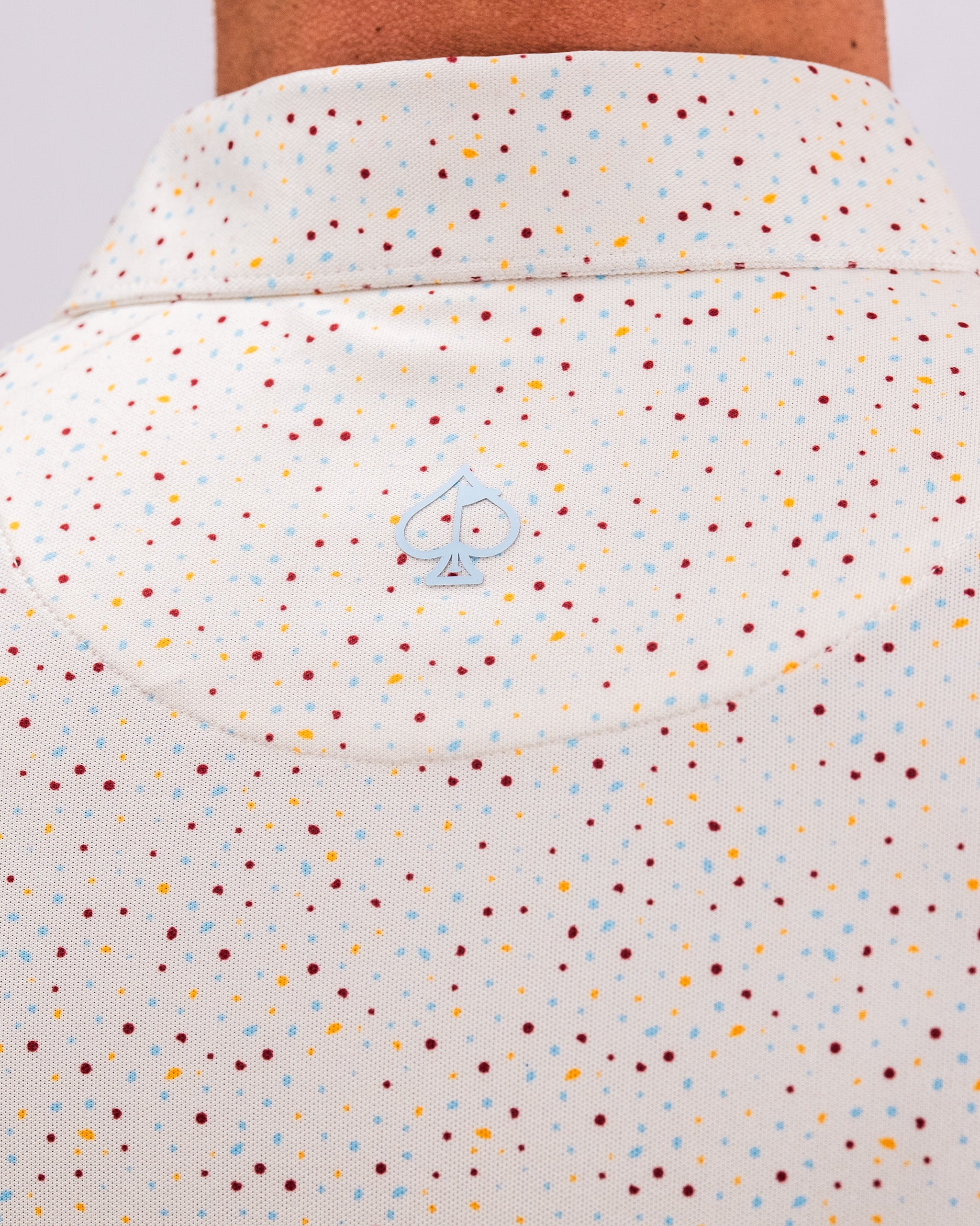 Player Preferred Polo in Terrazzo features a colorful speckled pattern and a subtle logo on the collar. Perfect for stylish golfers.