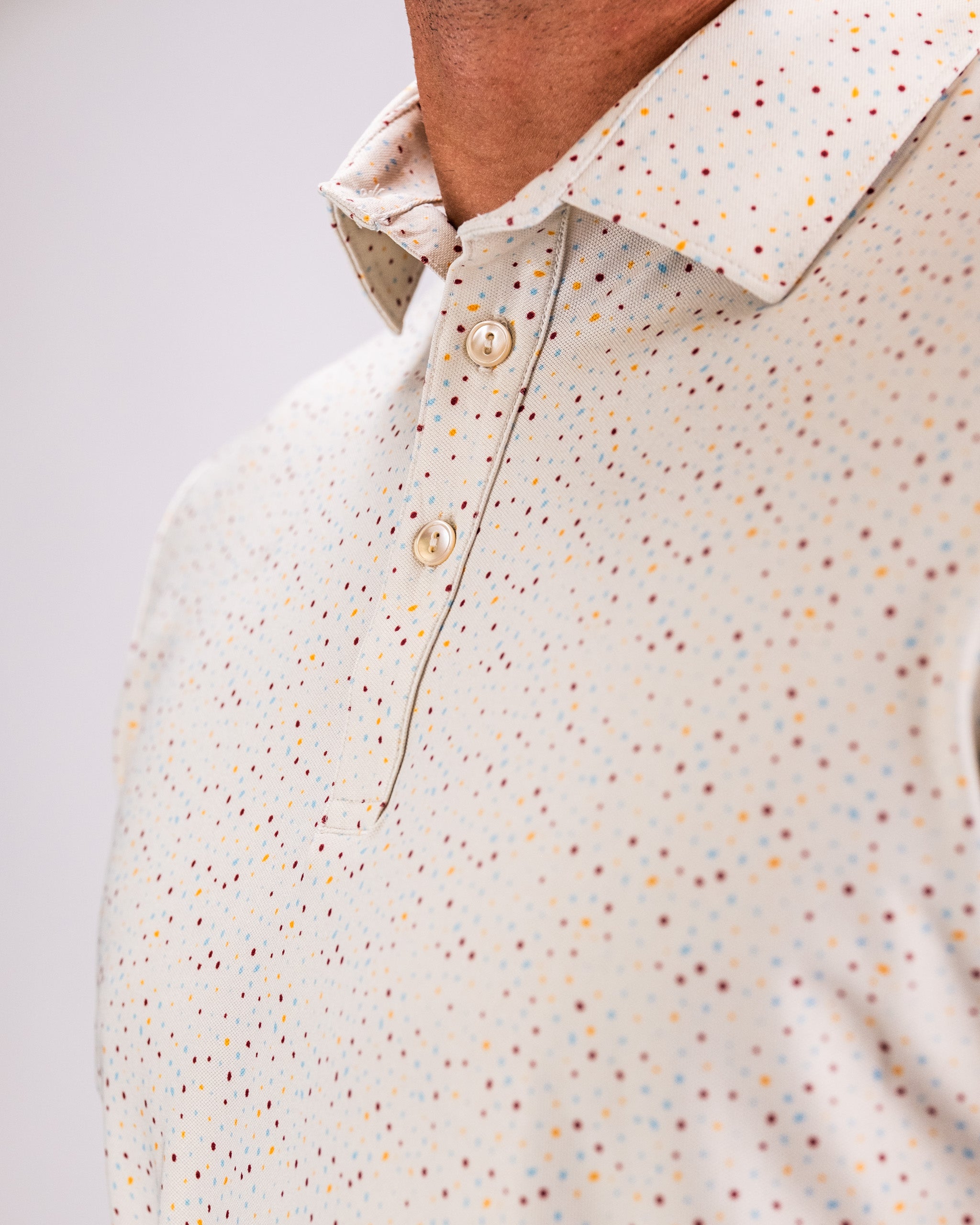 Player Preferred Polo in Terrazzo features a stylish dotted pattern, perfect for golfers seeking bold, unique apparel.