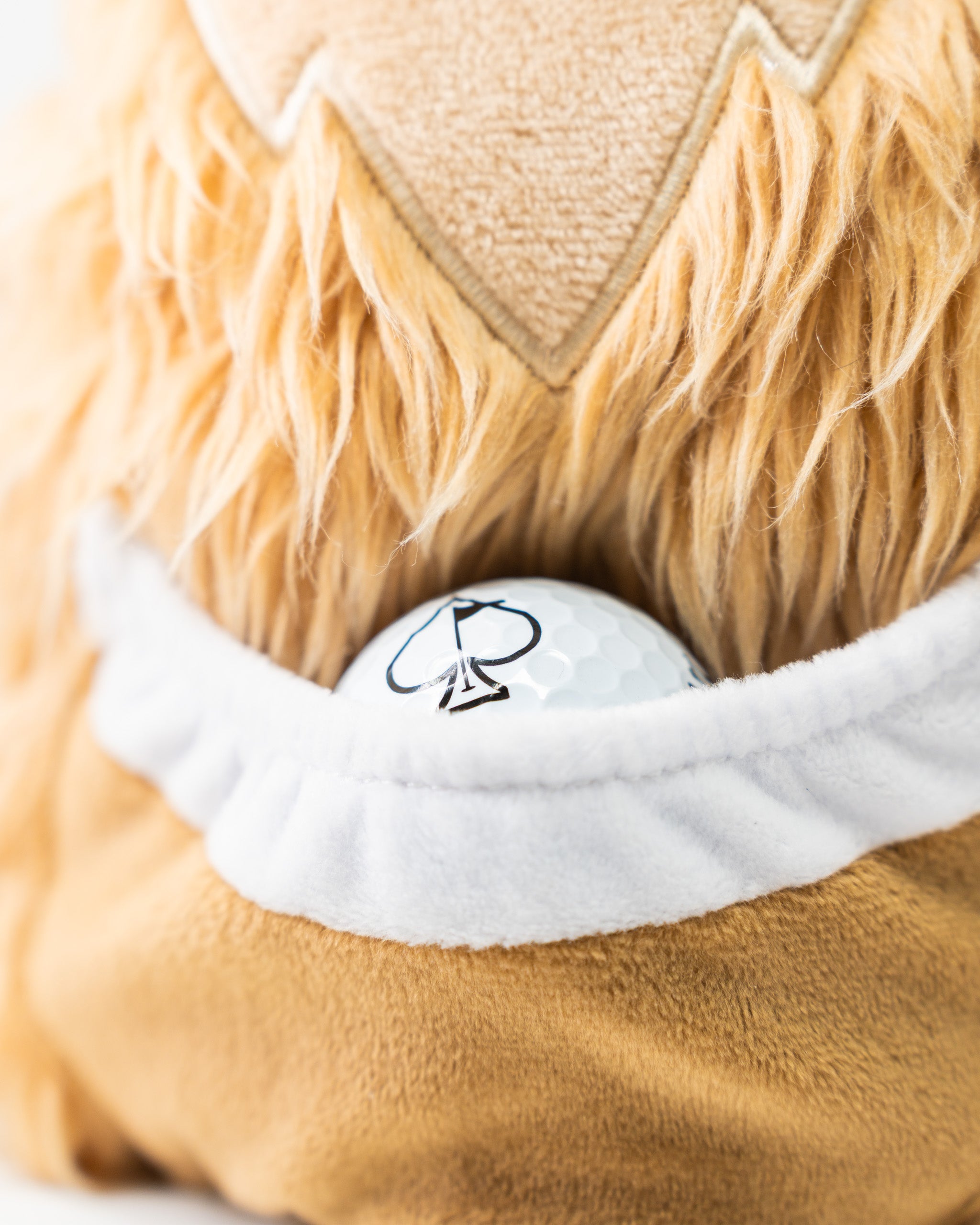 Kangaroo driver cover featuring a plush design with a pocket holding a golf ball, perfect for stylish golfers.