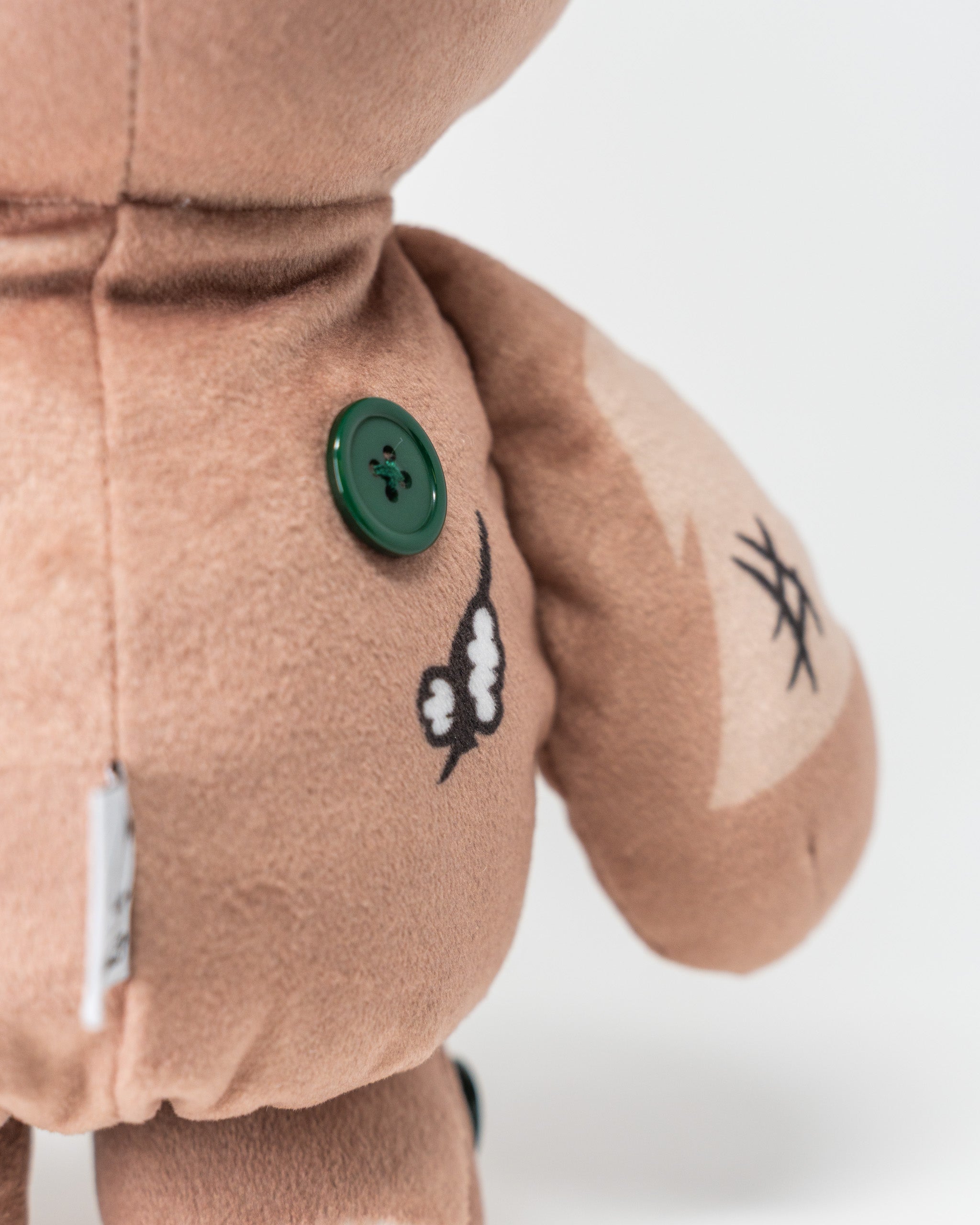 Voodoo doll driver cover featuring plush fabric, button details, and playful design for a unique golf accessory.