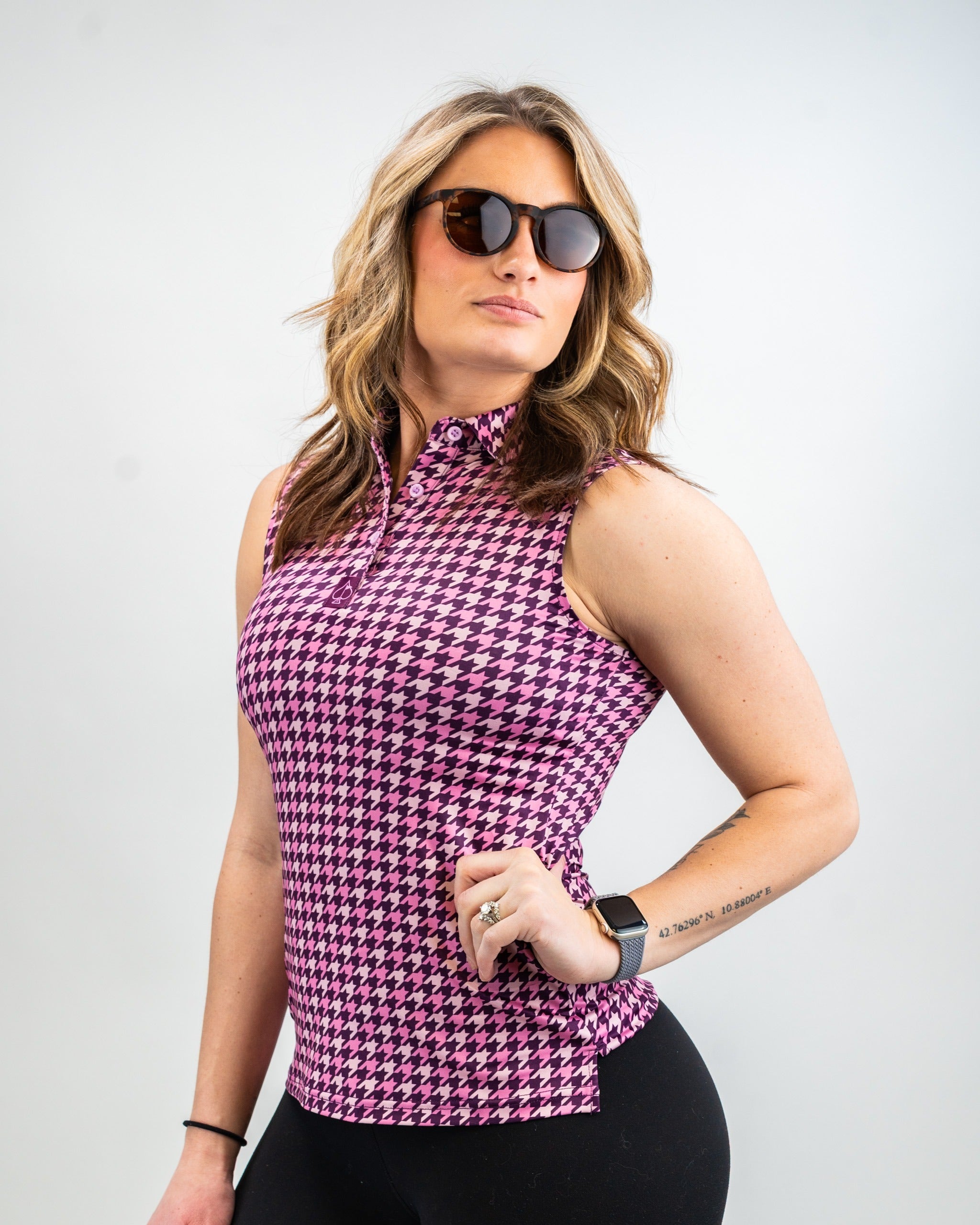 Women's houndstooth raspberry golf polo featuring a stylish zip-up design, perfect for a bold look on the course.