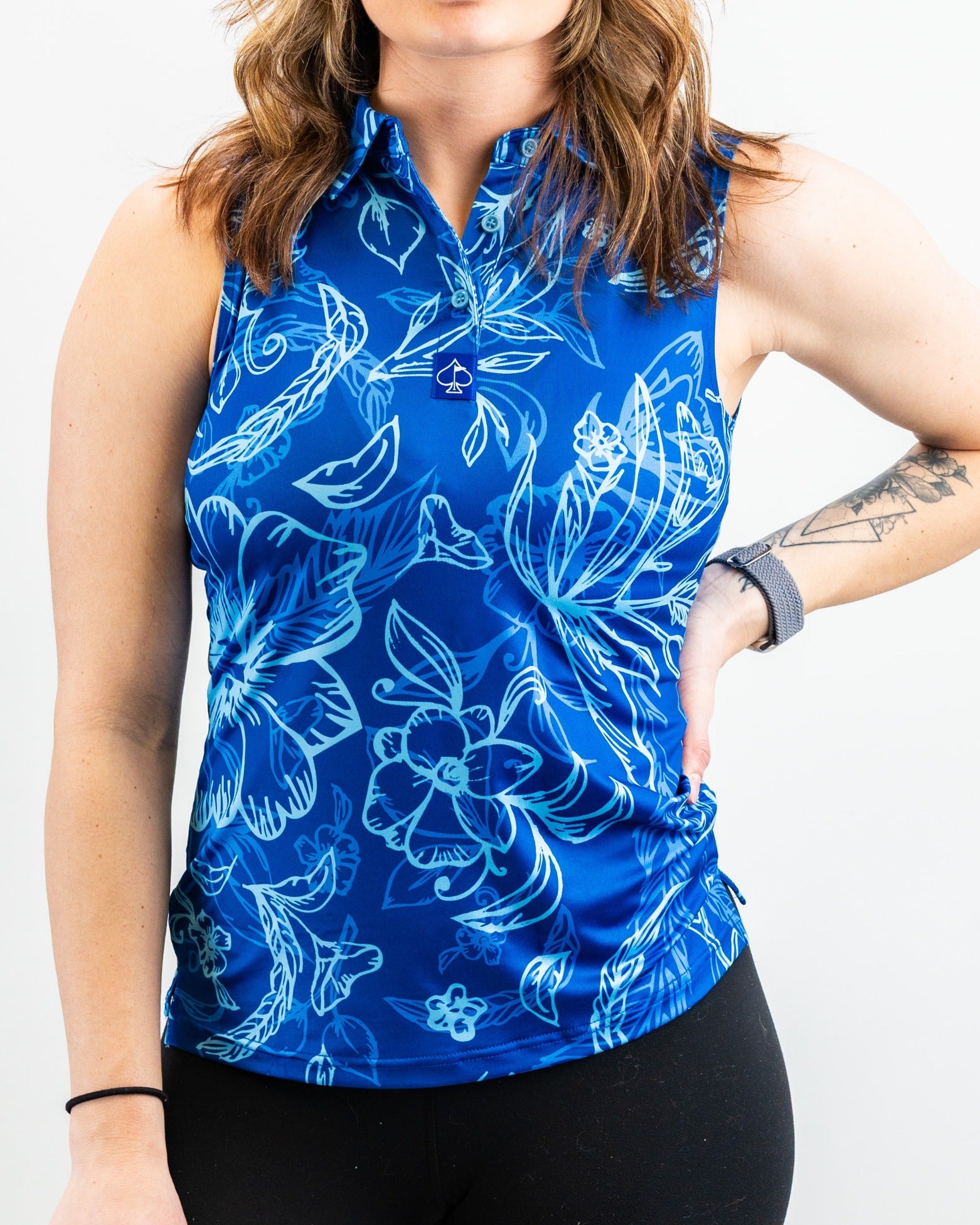 Women's Cabo Ocean sleeveless golf polo in vibrant blue with floral patterns, perfect for stylish performance on the course.