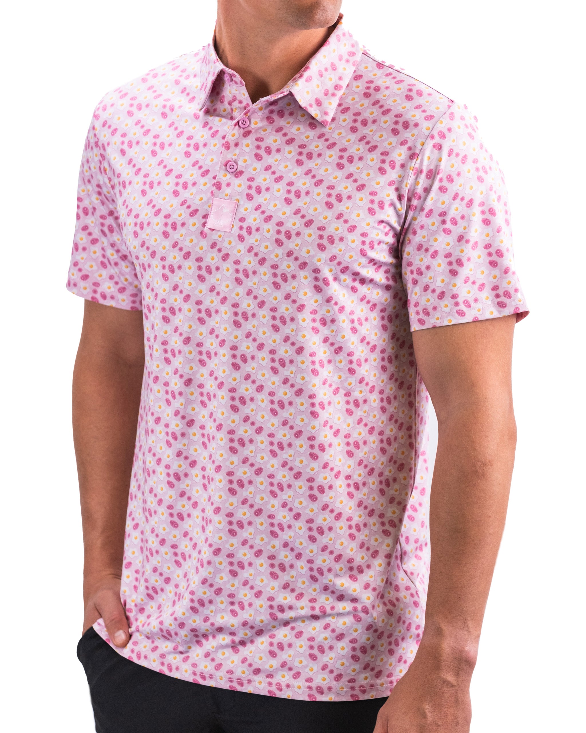 Men's short-sleeve golf shirt in pink with a playful pattern of eggs and ham, designed for a bold, stylish look on the course.