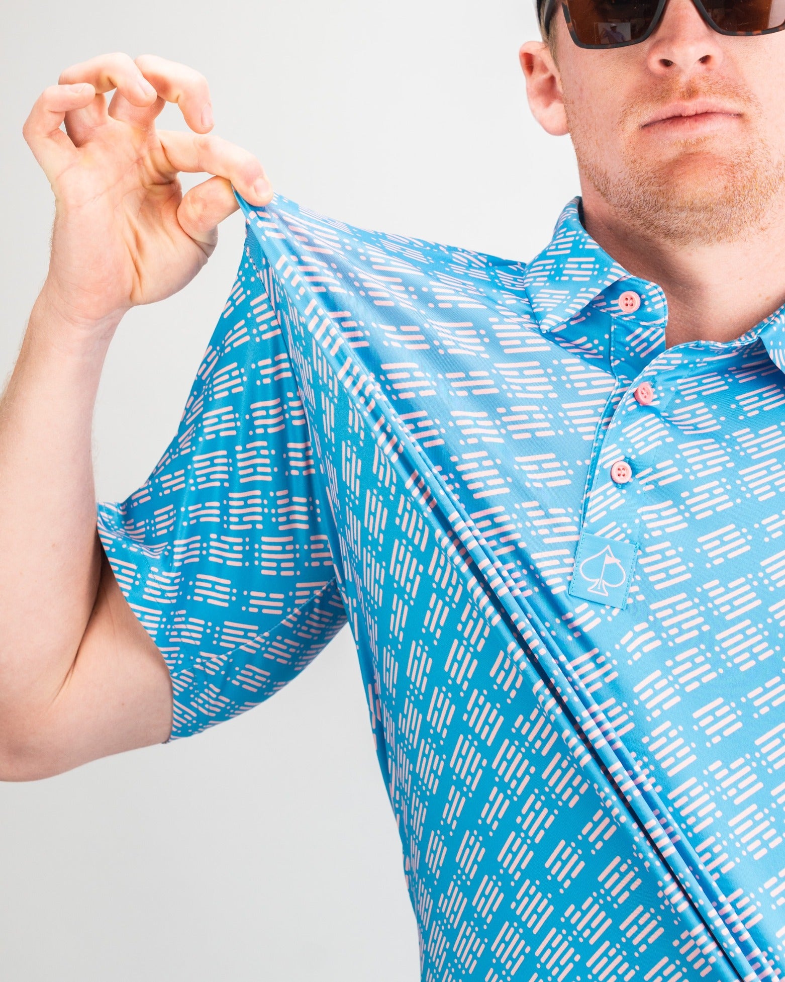 Bold blue golf polo featuring a unique skyline pattern, showcasing vibrant colors and a relaxed fit for stylish performance.