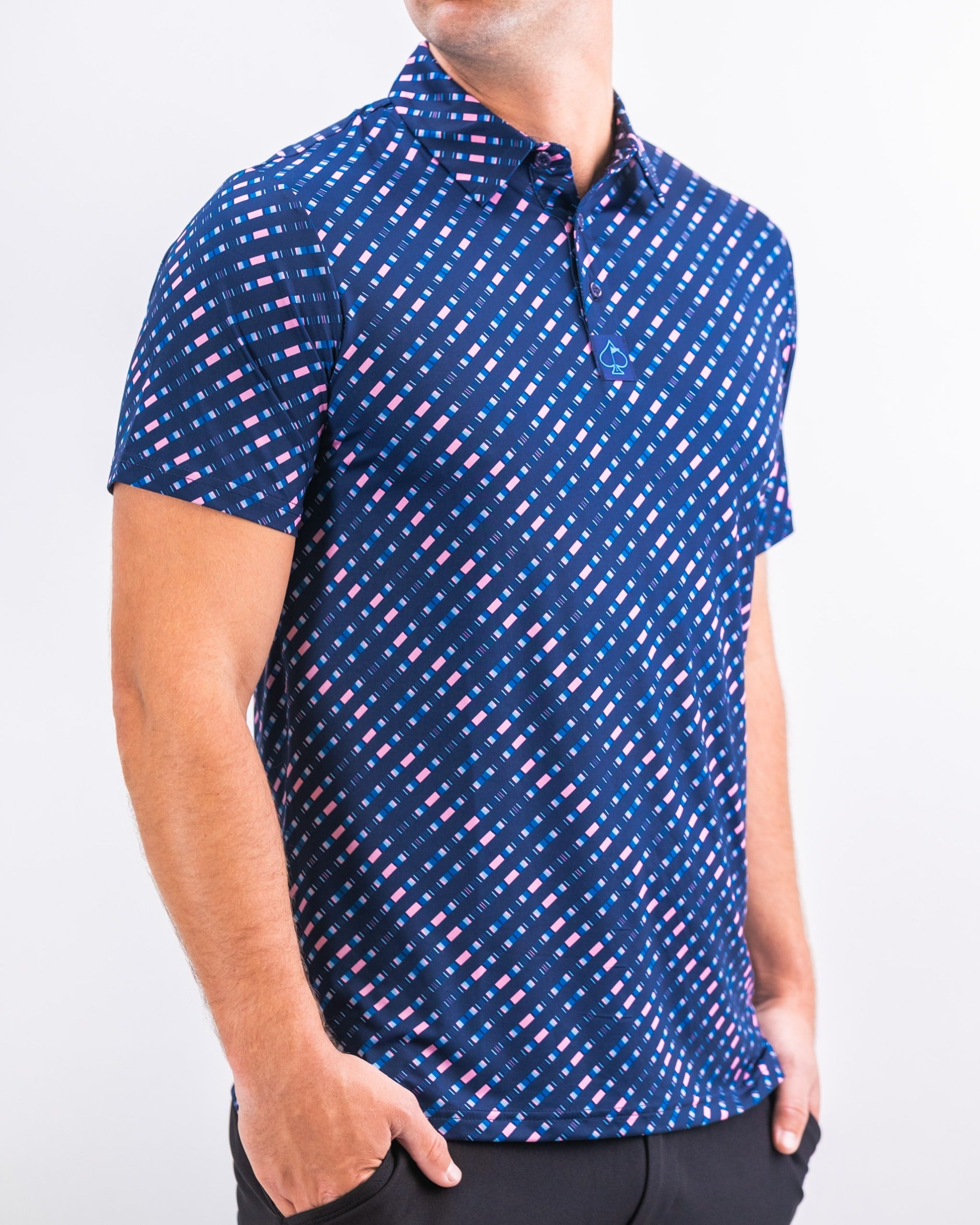 Men's Chromo Blue golf polo featuring a bold geometric pattern in blue, pink, and white, designed for stylish performance on the course.