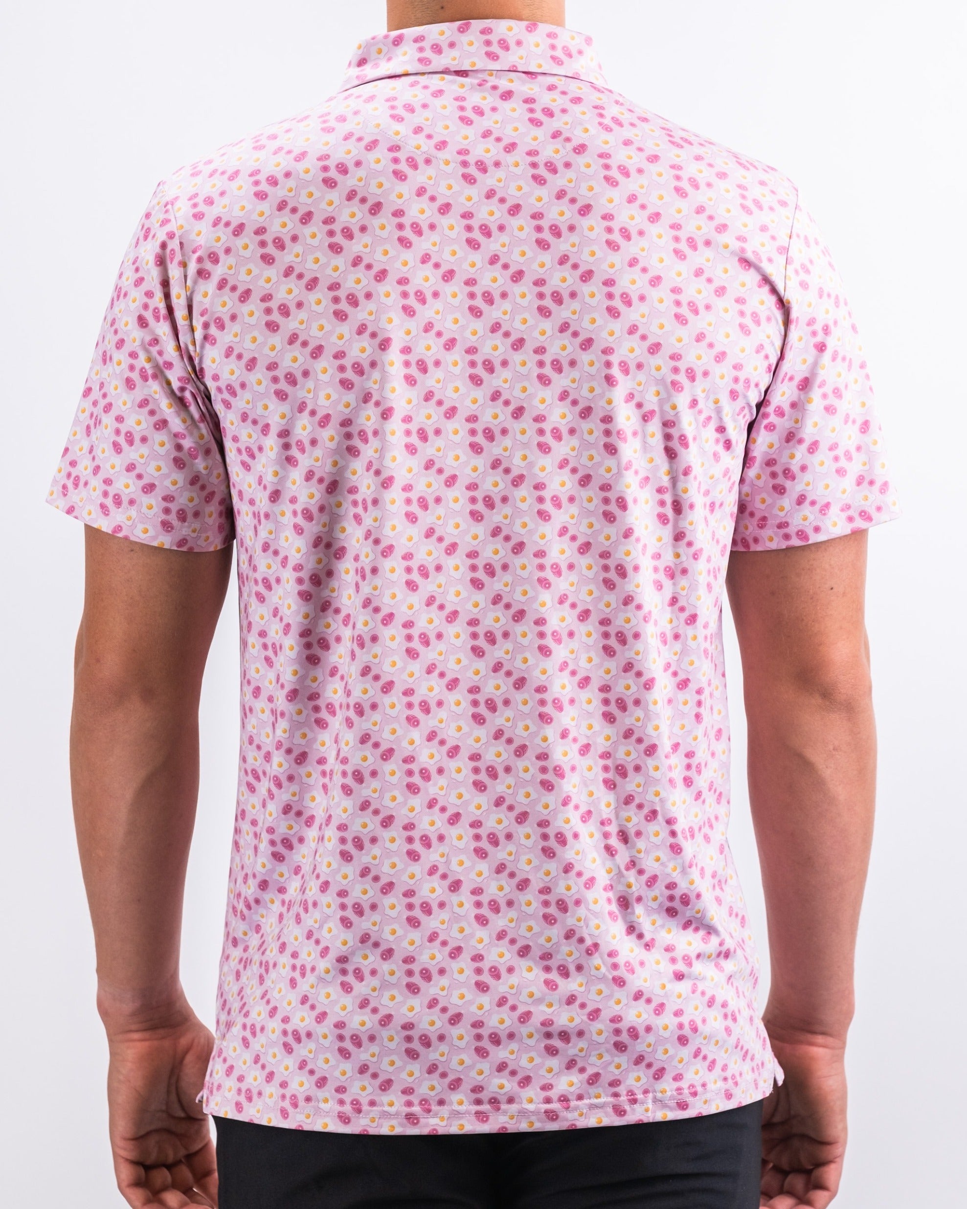 Men's pink golf shirt featuring a playful ham and egg pattern, perfect for adding fun to your golf wardrobe.