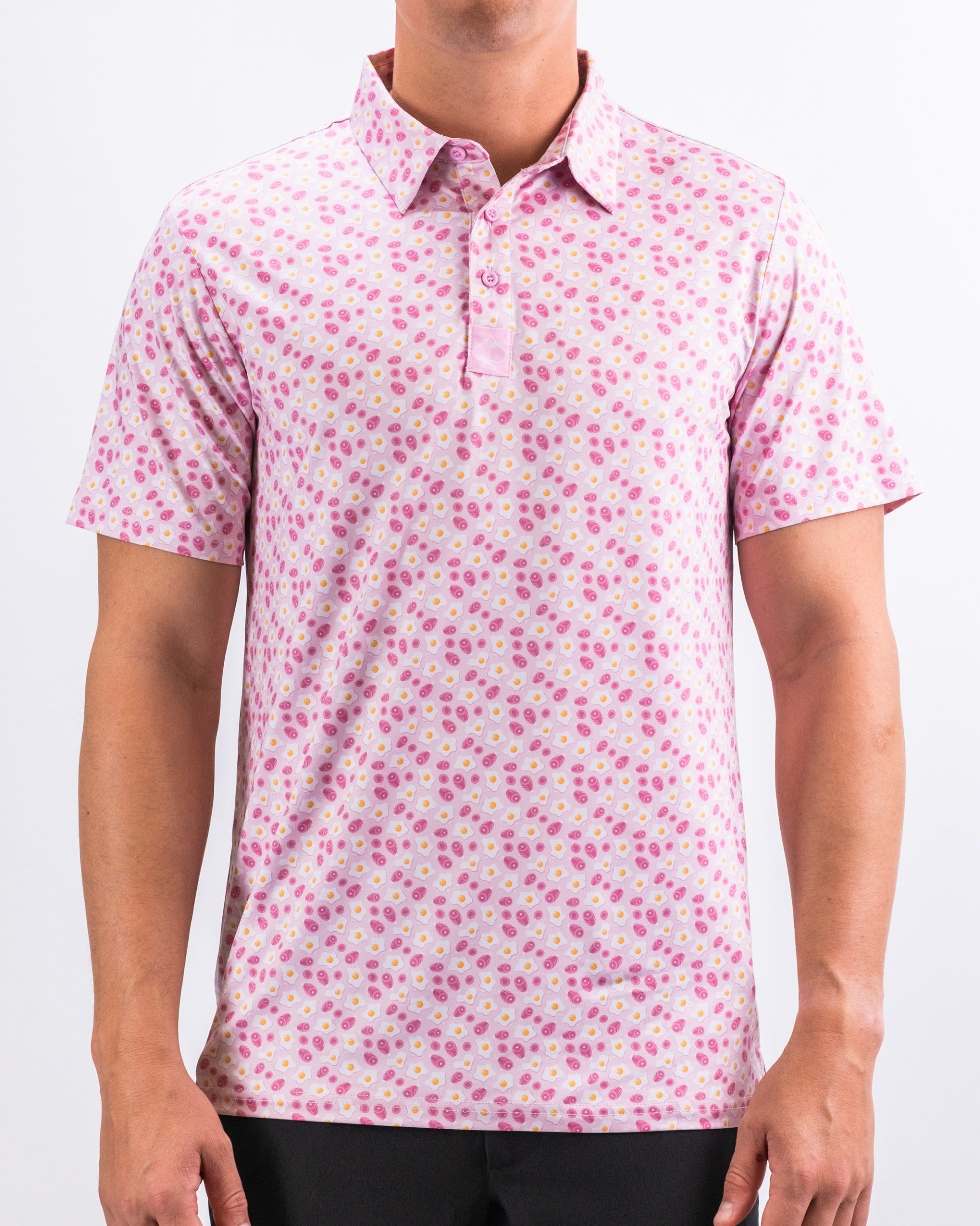 Men's pink golf polo shirt featuring a playful pattern of colorful circles, perfect for a bold look on the course.