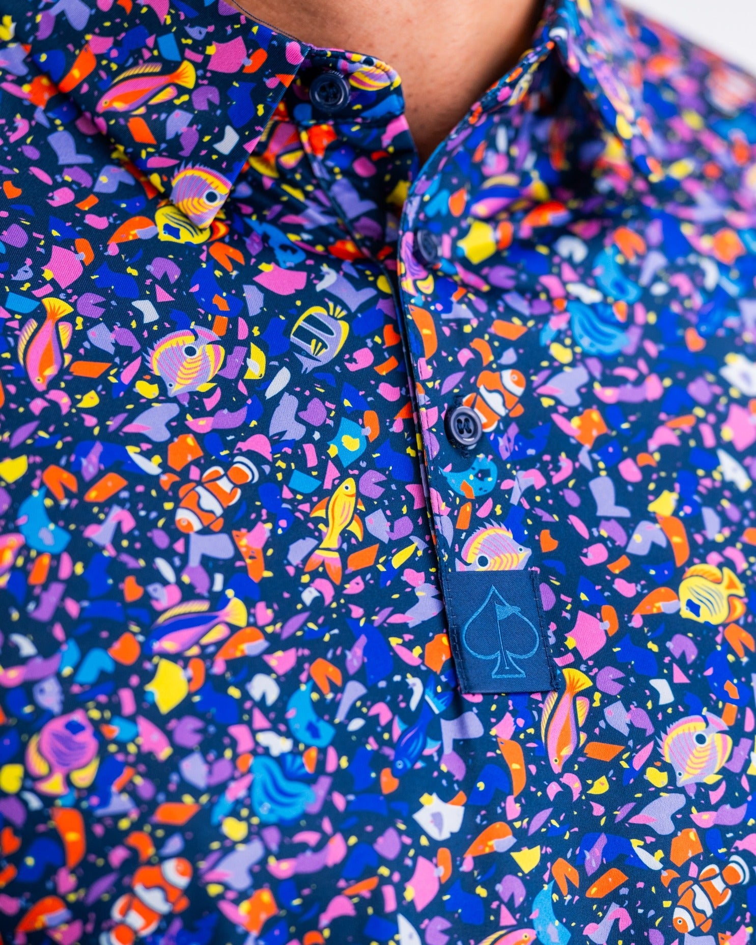 Vibrant tropical print shirt featuring colorful abstract designs, perfect for golfers seeking bold style on the course.