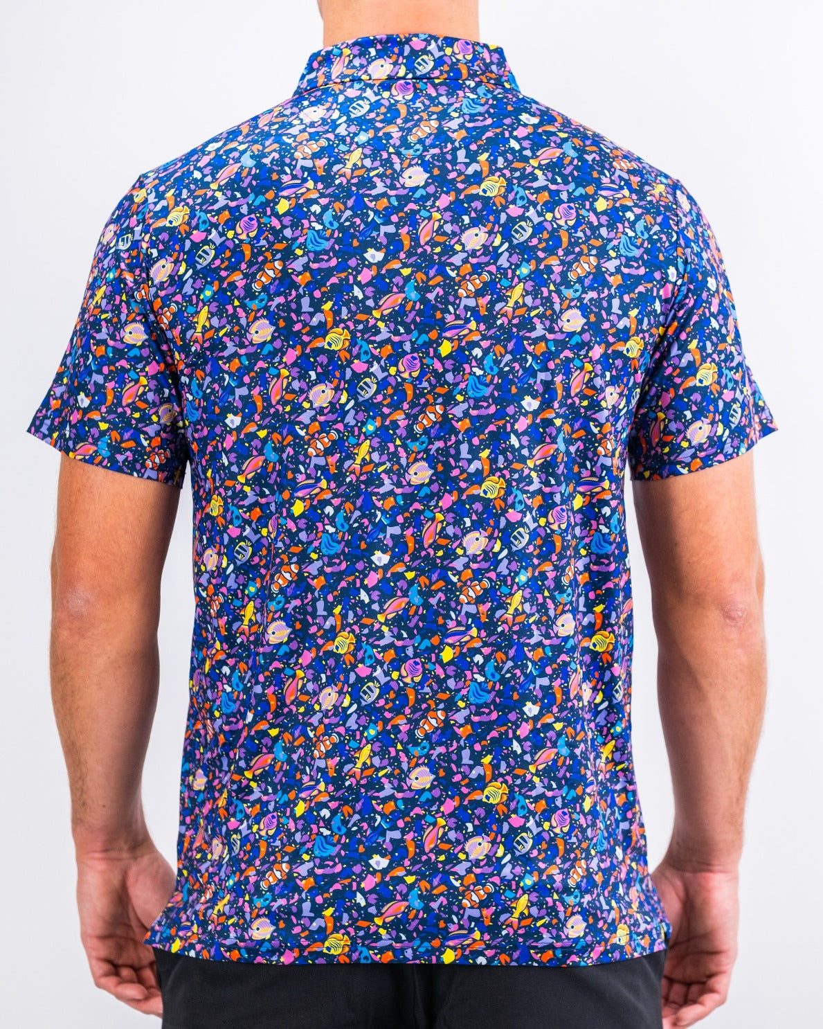 Men's short-sleeve shirt featuring a vibrant tropical pattern with colorful shapes and designs, perfect for standout golf style.