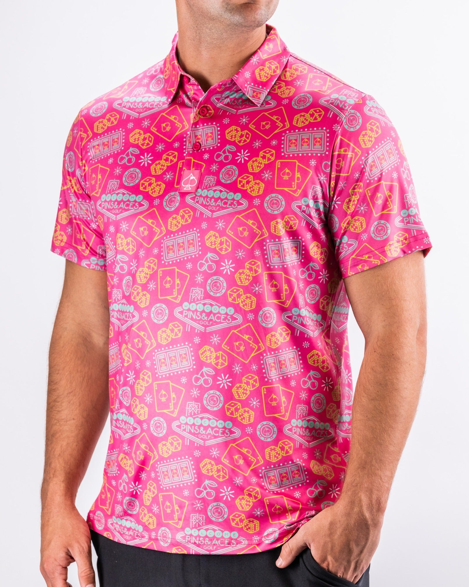 Bold fuchsia golf polo featuring a playful pattern of colorful casino-themed graphics, perfect for standout style on the course.