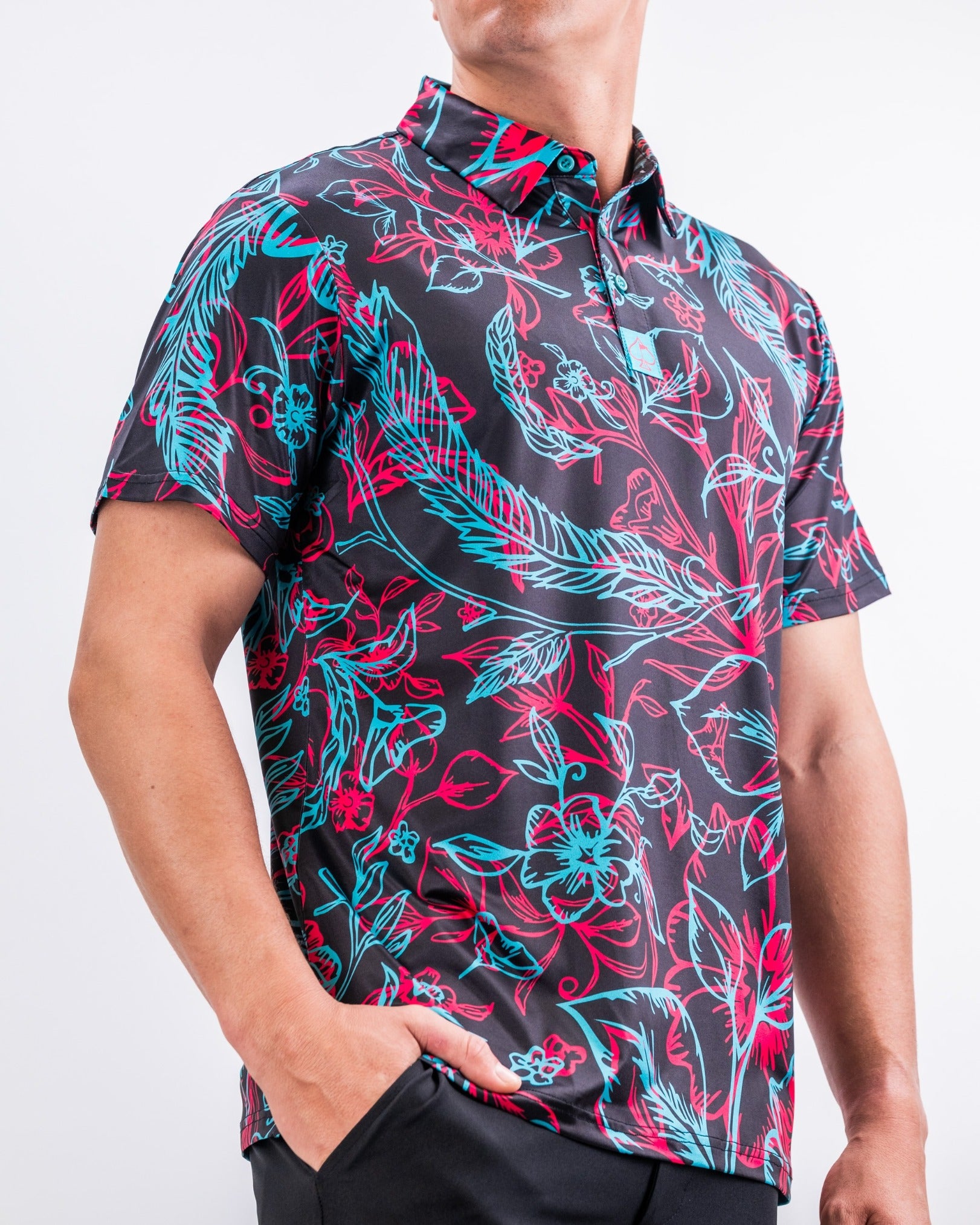 Bold floral-patterned golf shirt in black, featuring vibrant red and blue designs, perfect for stylish golfers.