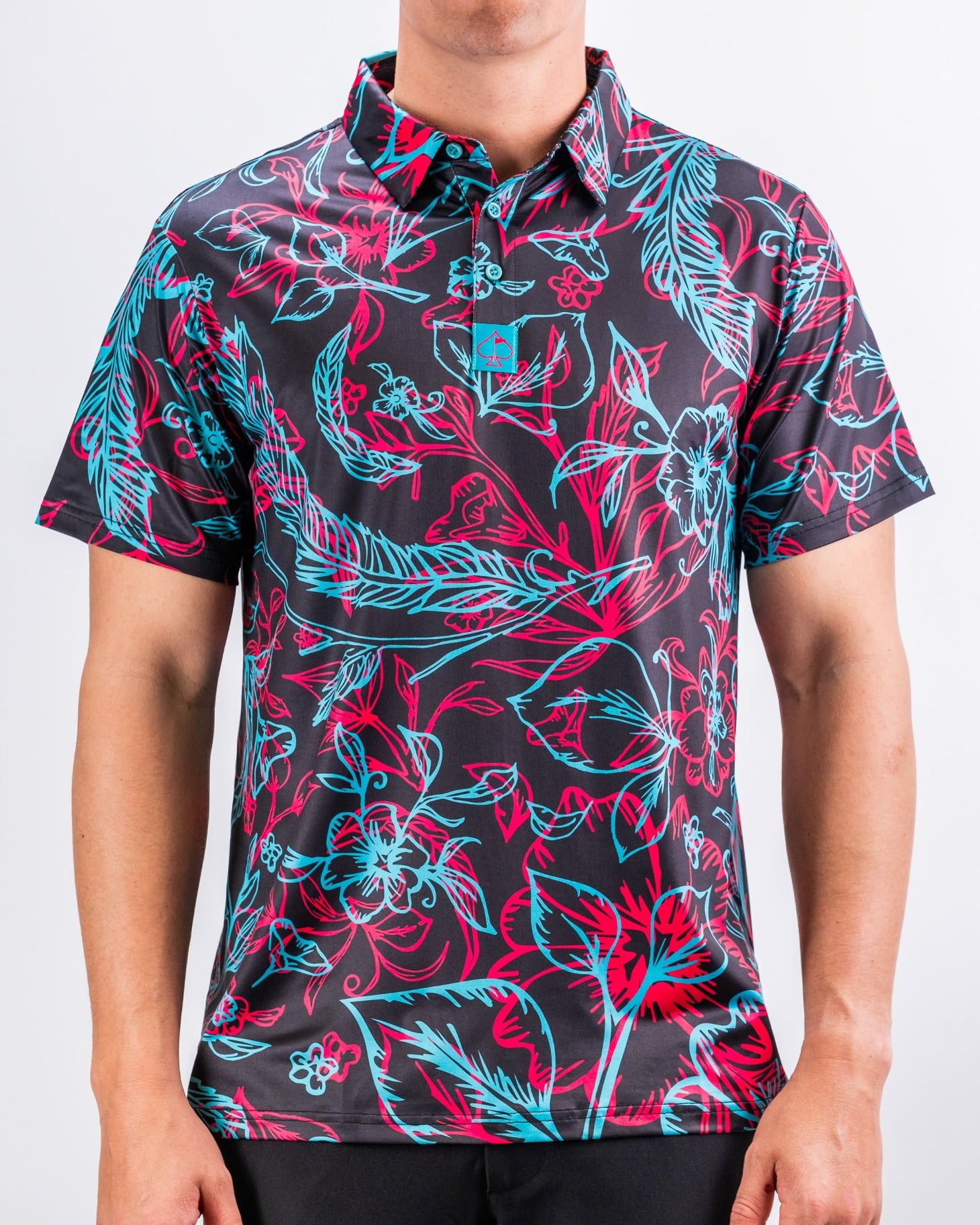 Men's short-sleeve golf shirt featuring a vibrant floral pattern in pink and turquoise on a black background.
