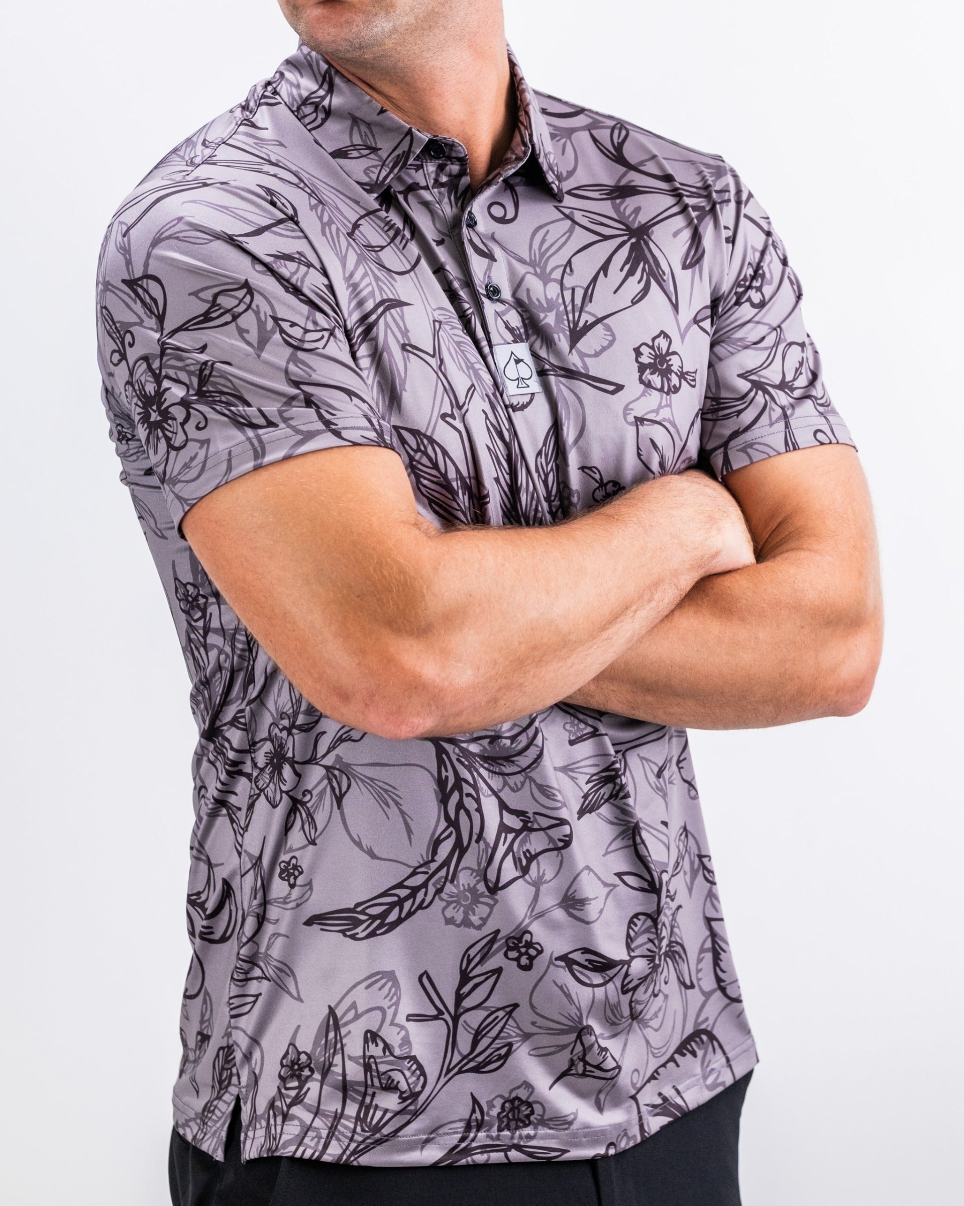 Men's Cabo Midnight golf polo featuring a bold floral design in shades of gray, perfect for stylish performance on the course.