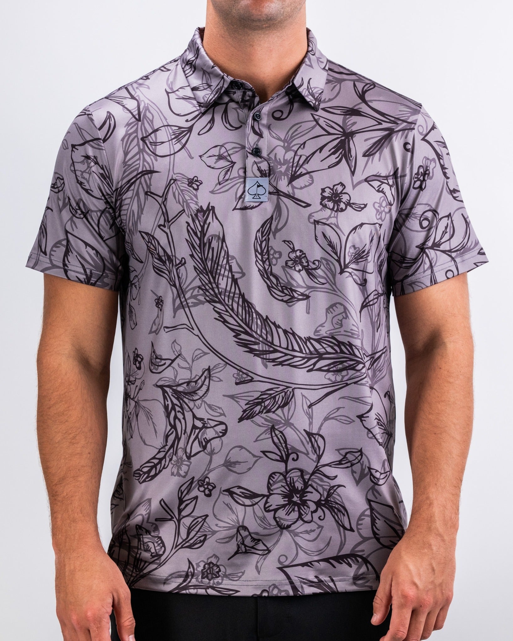 Men's short-sleeve golf polo in dark gray with a floral and feather pattern, designed for a stylish look on the course.